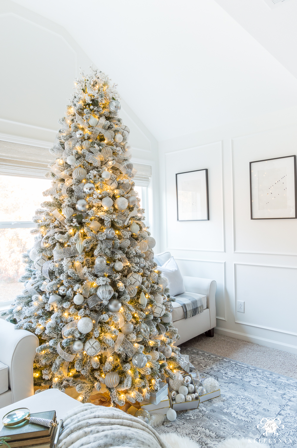 Silver and white flocked Christmas tree in the bedroom