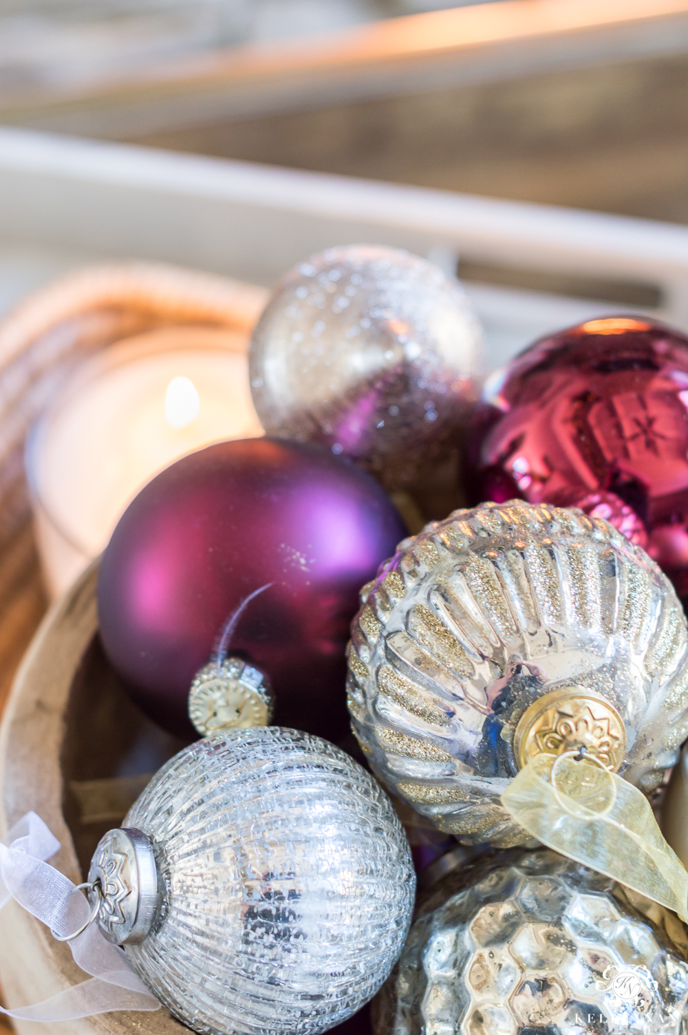 Deep red, champagne, and gold ornaments in a bowl