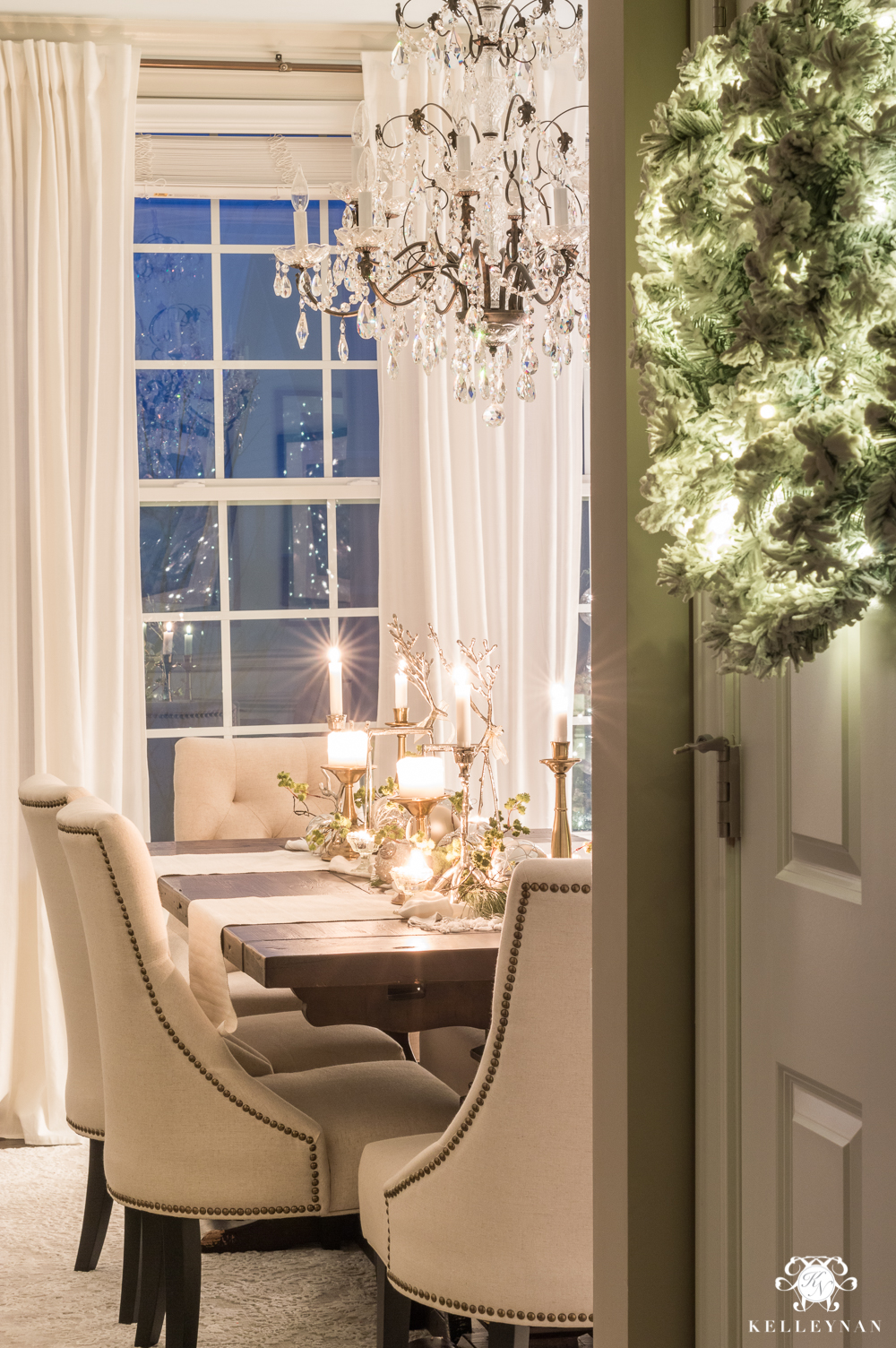 Christmas dining room with candle centerpiece at twilight