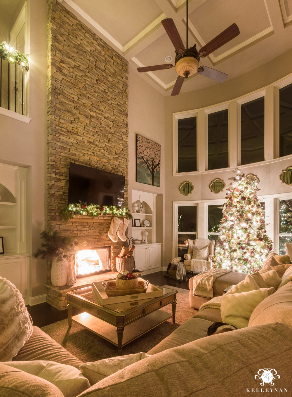 Two story christmas living room at night with fire