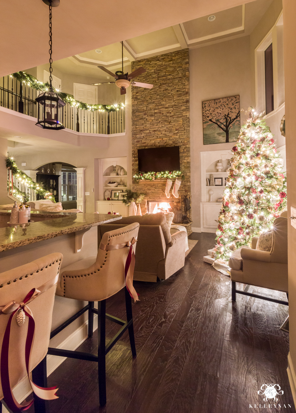 Two story christmas living room with glowing christmas lights