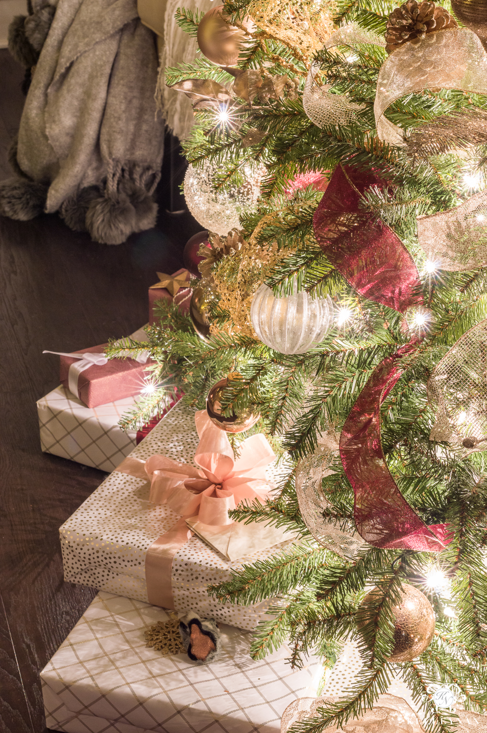Christmas presents underneath twinkling tree