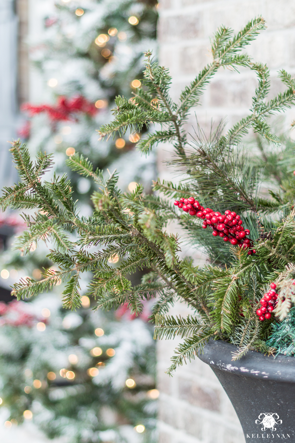 Fresh and Faux greenery in outdoor urns for the holidays