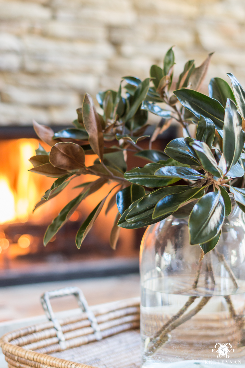 Bunch of magnolia leaves in a clear glass vase