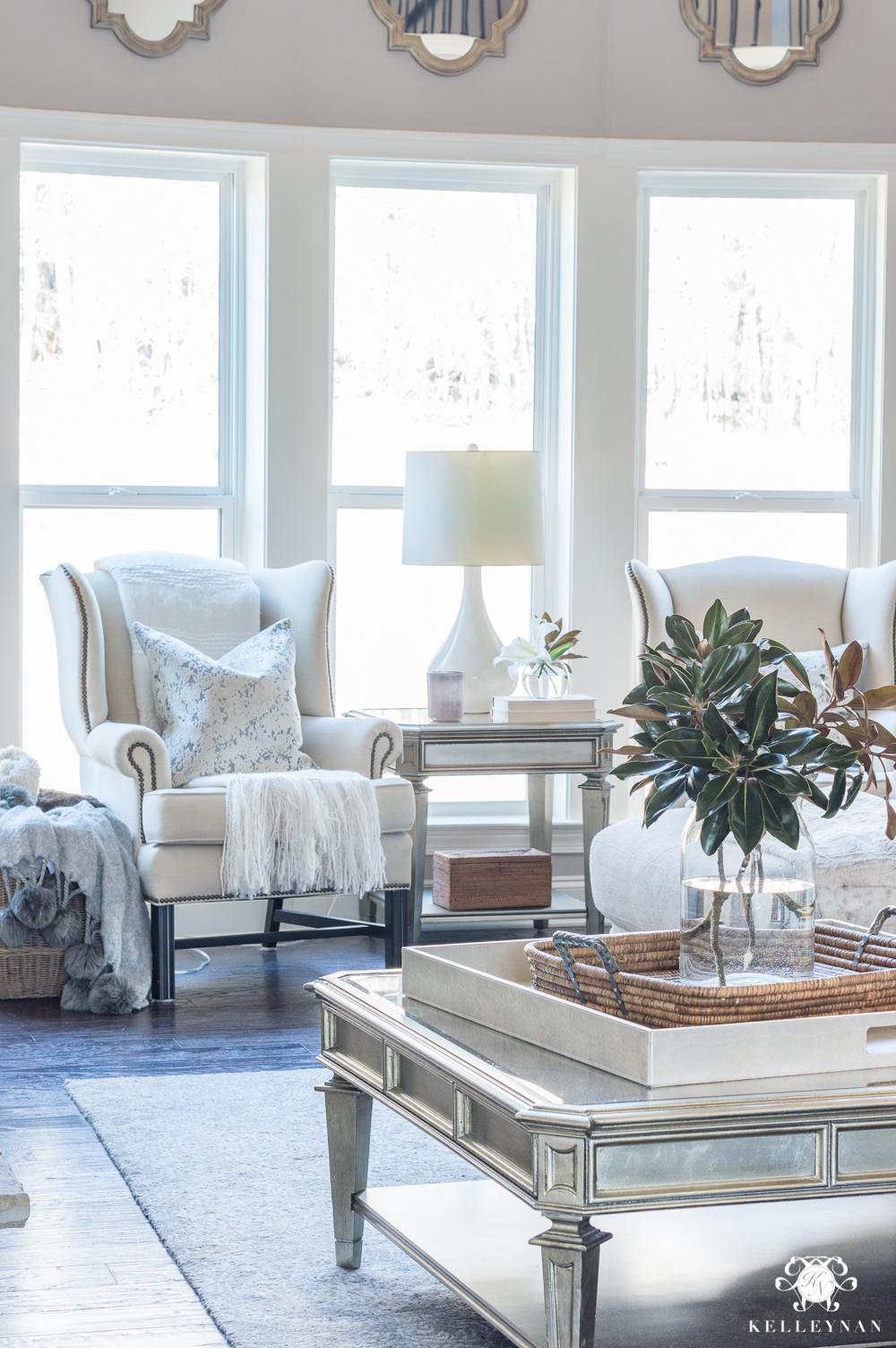 Crating a sitting nook with a pair of wingback chairs in the living room