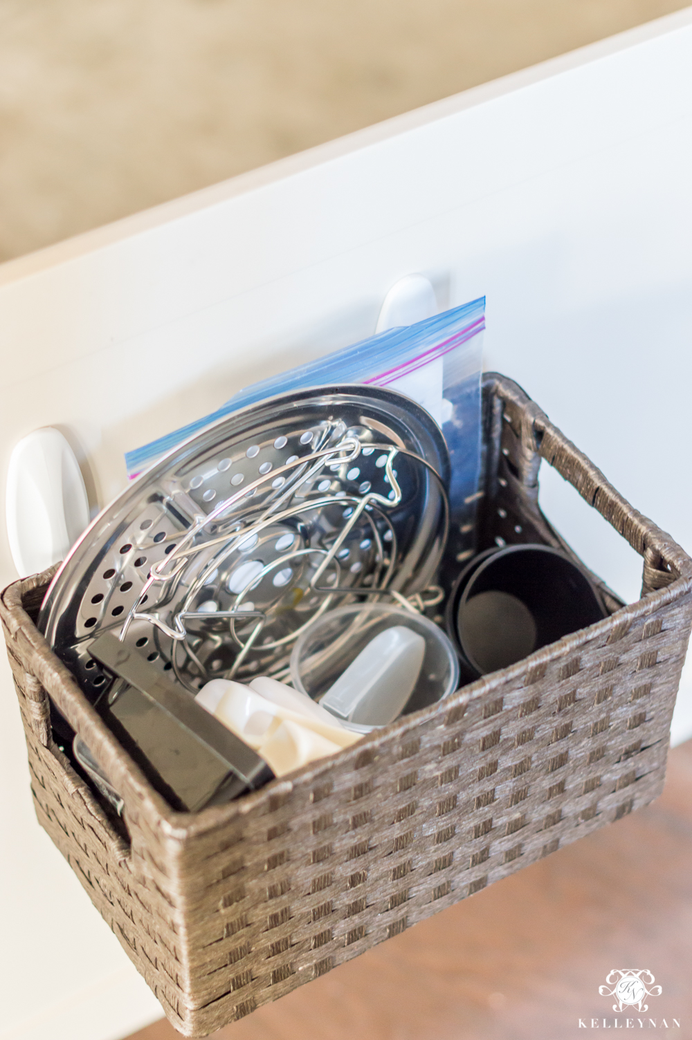 Hanging a storage basket inside the cabinet for small appliance parts