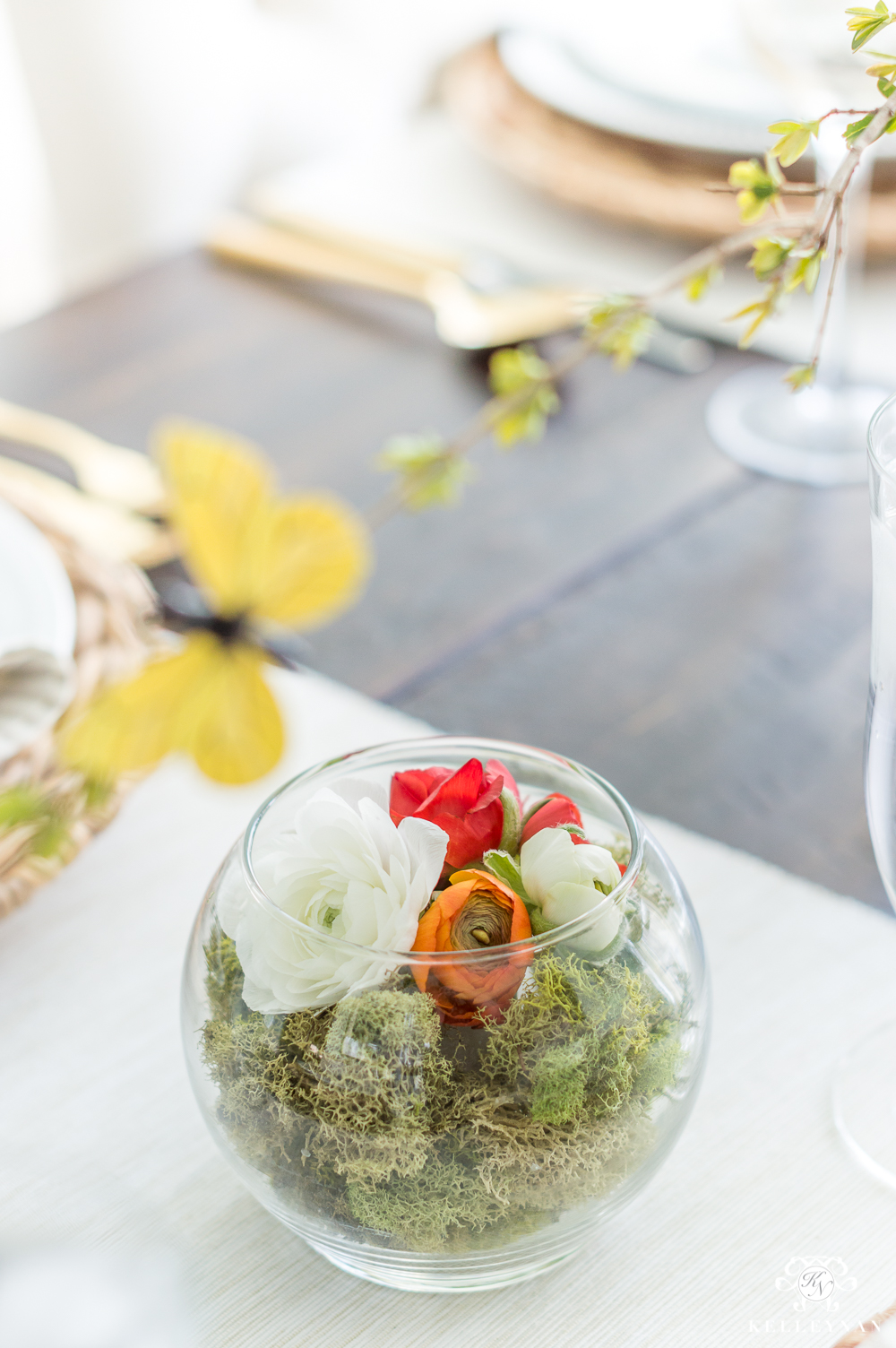 Ranunculus Terrariums on a spring table with moss