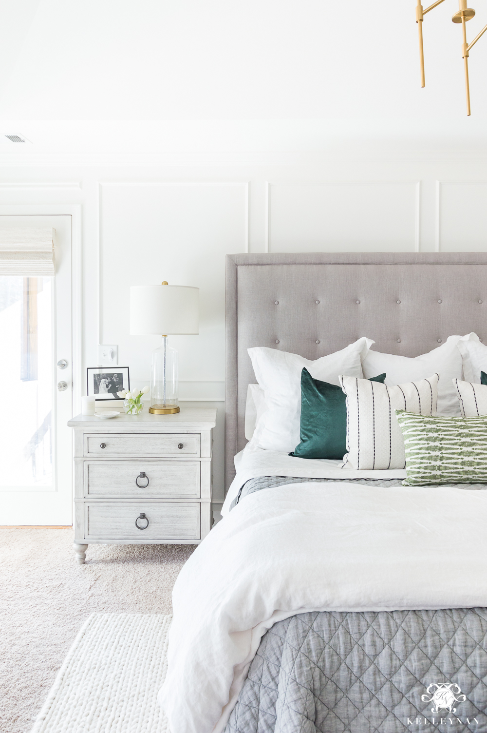 Master Bedroom Design with Gray Tufted Bed and Green Accents