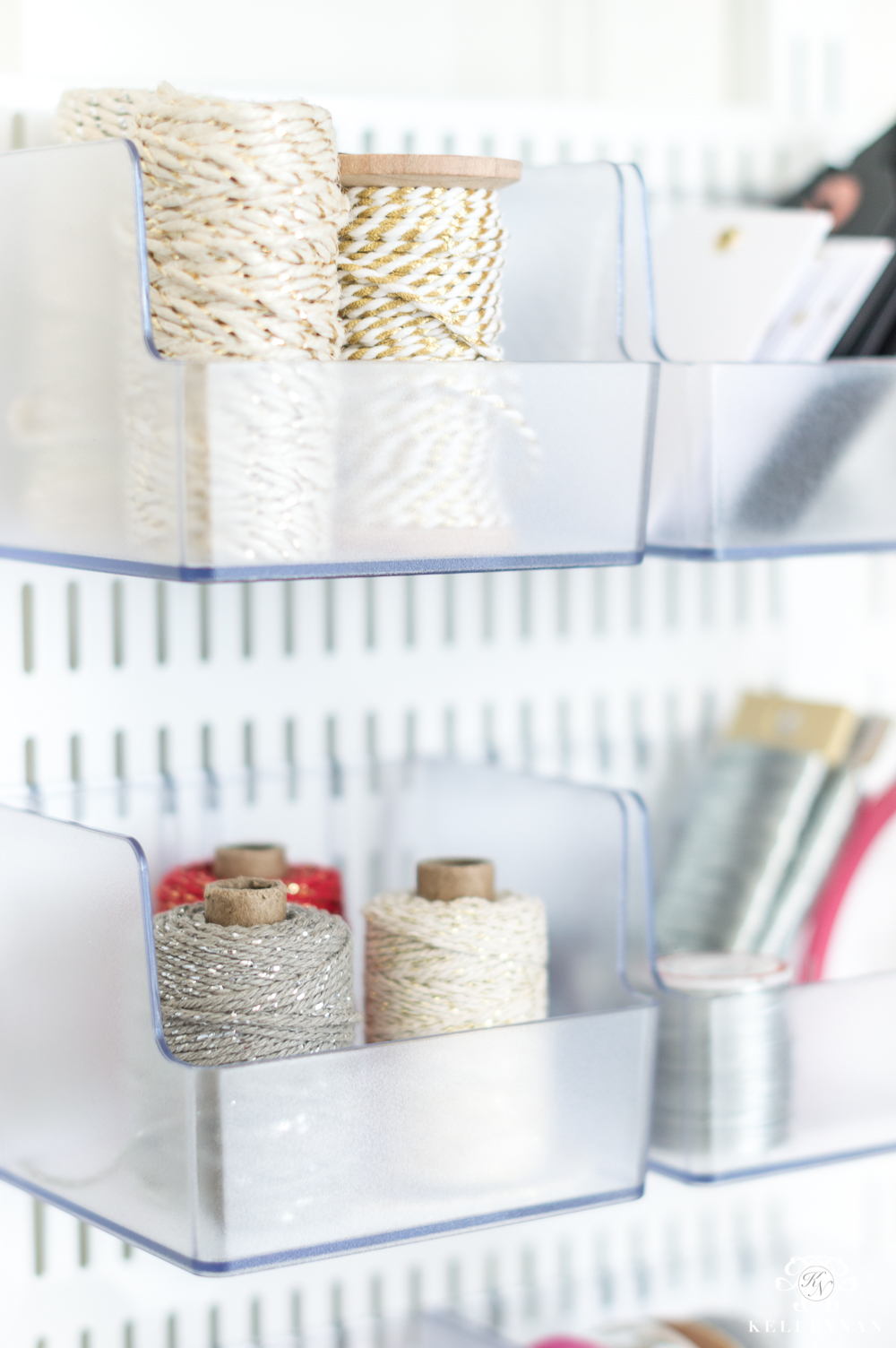 Organized twine and ribbon in the back of the door gift wrap station