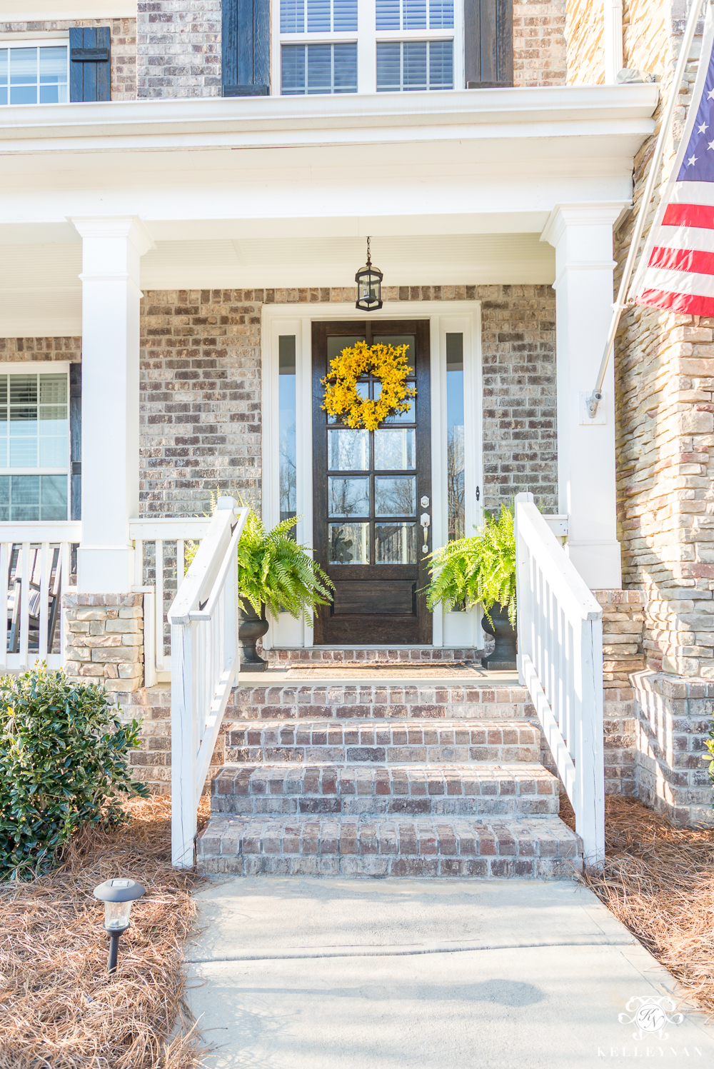 Spring Front Door with Yellow wreath and ferns for spring- front door and porch ideas