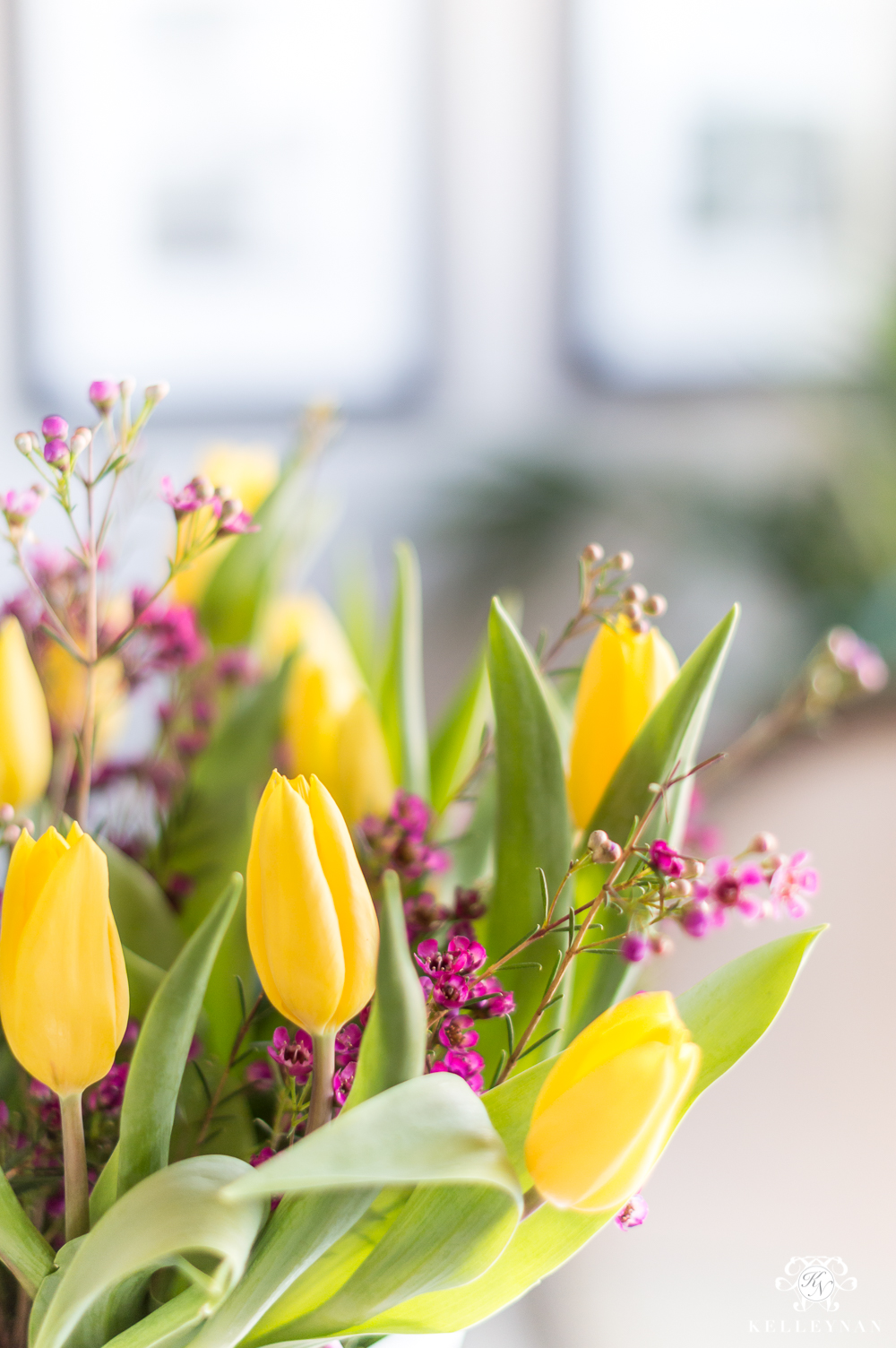 Yellow tulips and purple flowers in arrangement