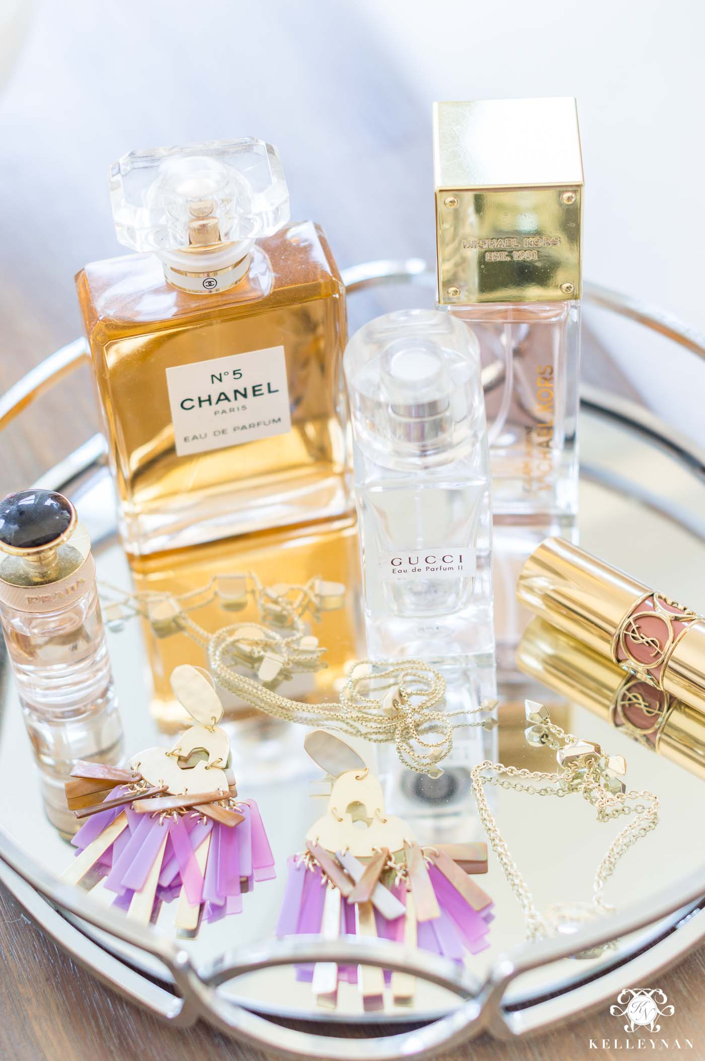 Displaying pretty perfume and jewelry on a mirrored tray in the bedroom for dresser decor