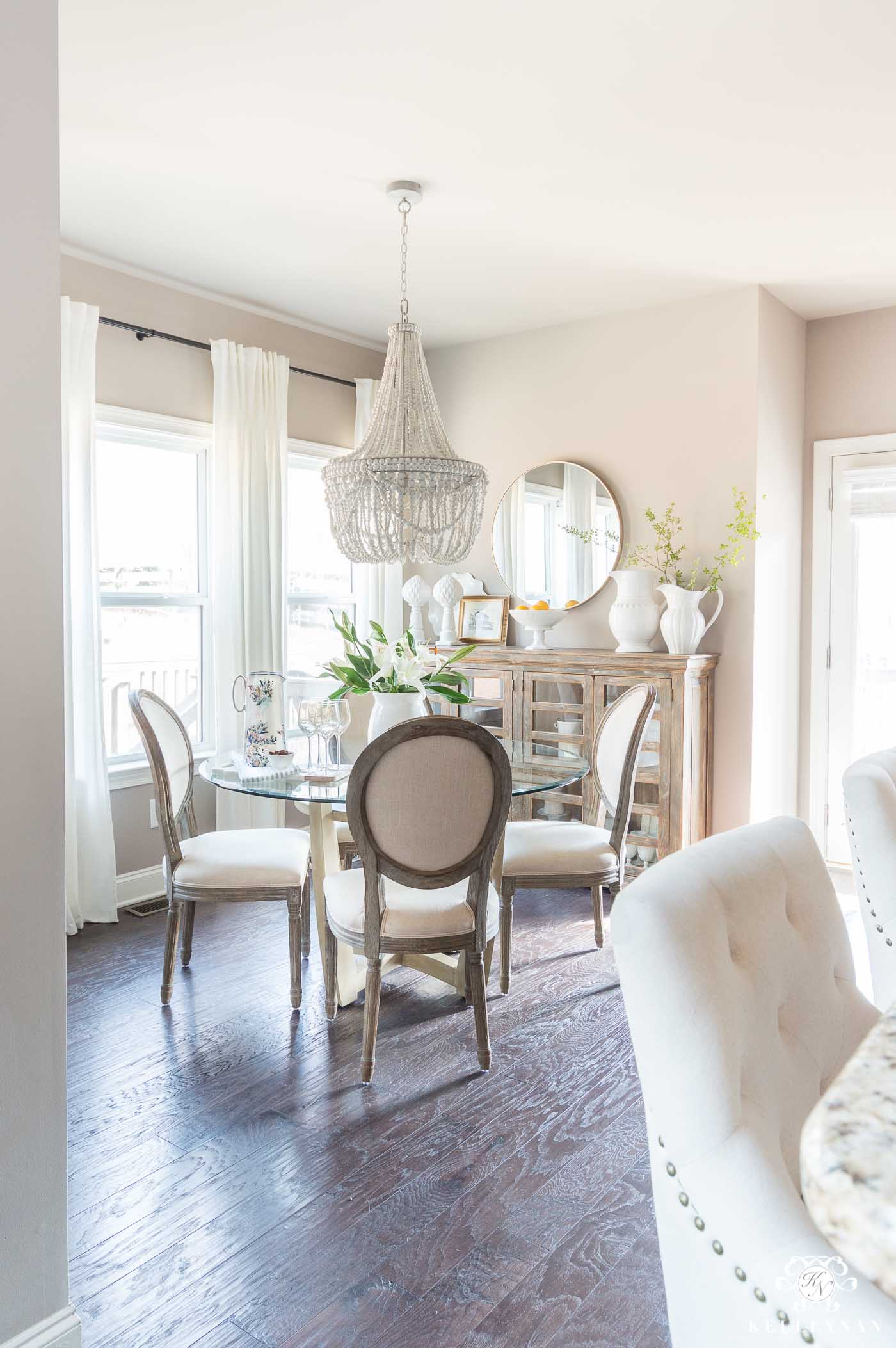 Gray wood bead chandelier over dining table