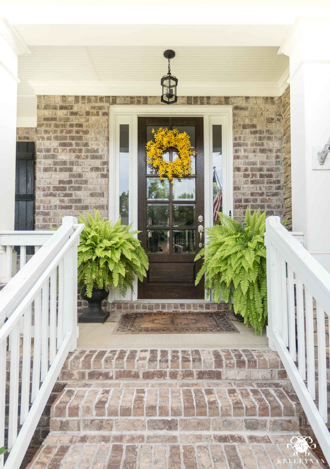 Huge Boston ferns in urns as an idea for front porch plants