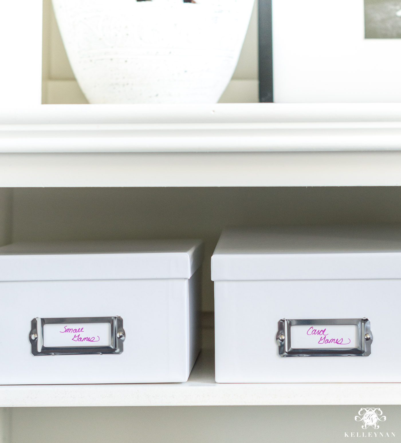 Small bins holding organized games and playing cards