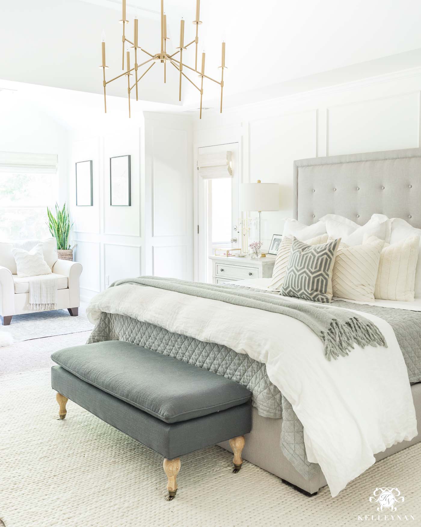 Neutral Master Bedroom with modern gray tufted bed and white simply white benjamin moore walls