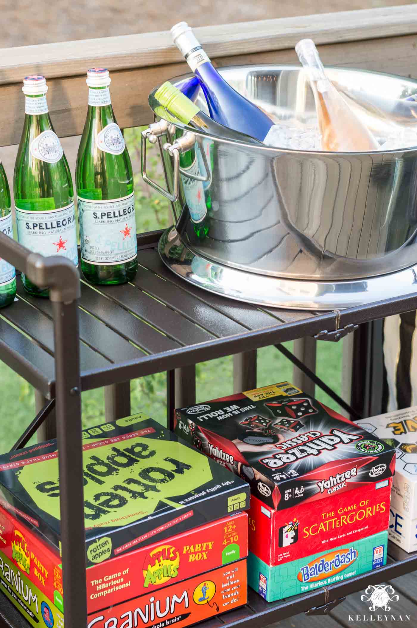 Bar cart filled with games for summer game night