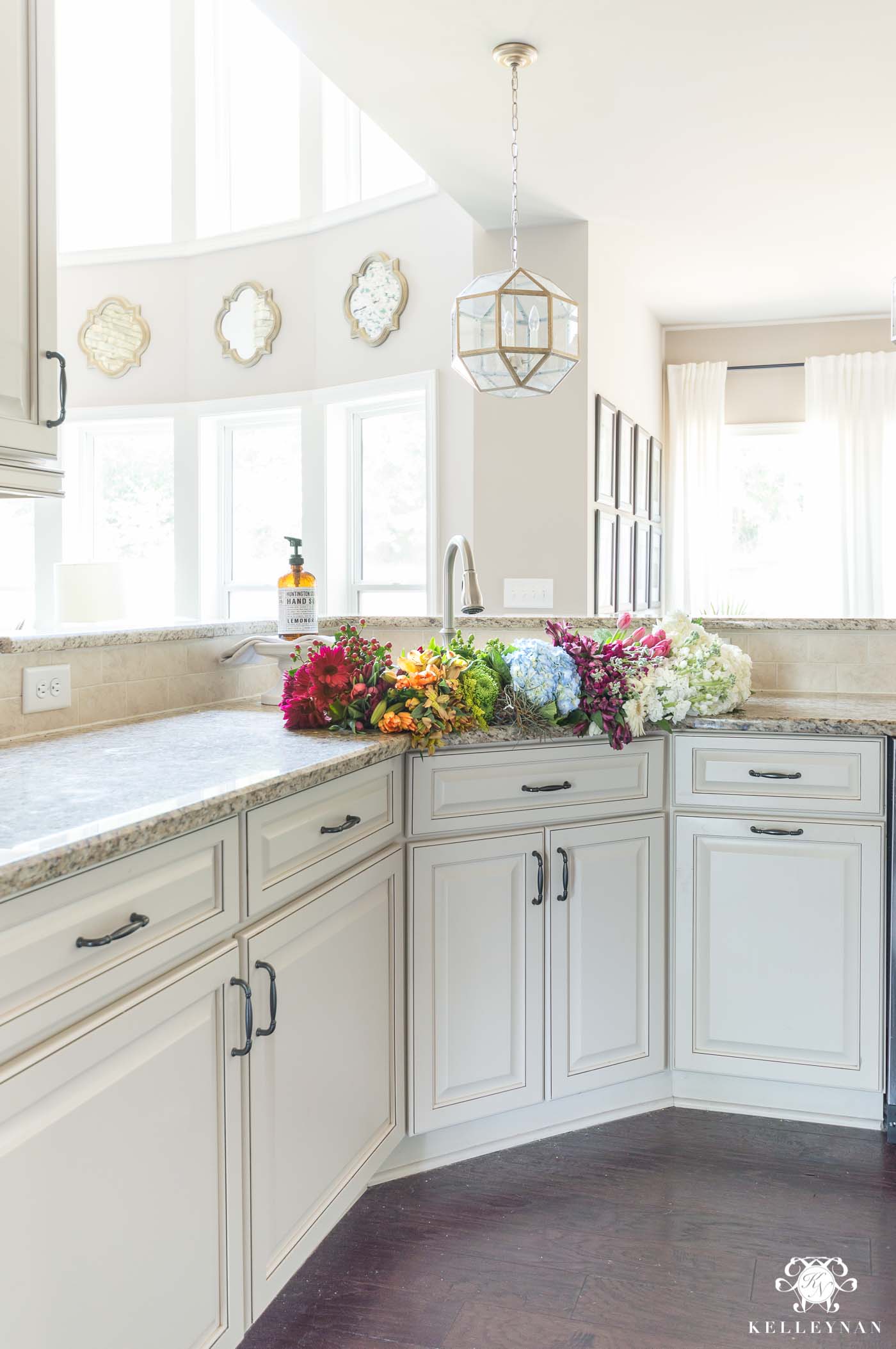 Traditional Kitchen With Cream Cabinets And Glaze With Rainbow Flowers In The Sink 