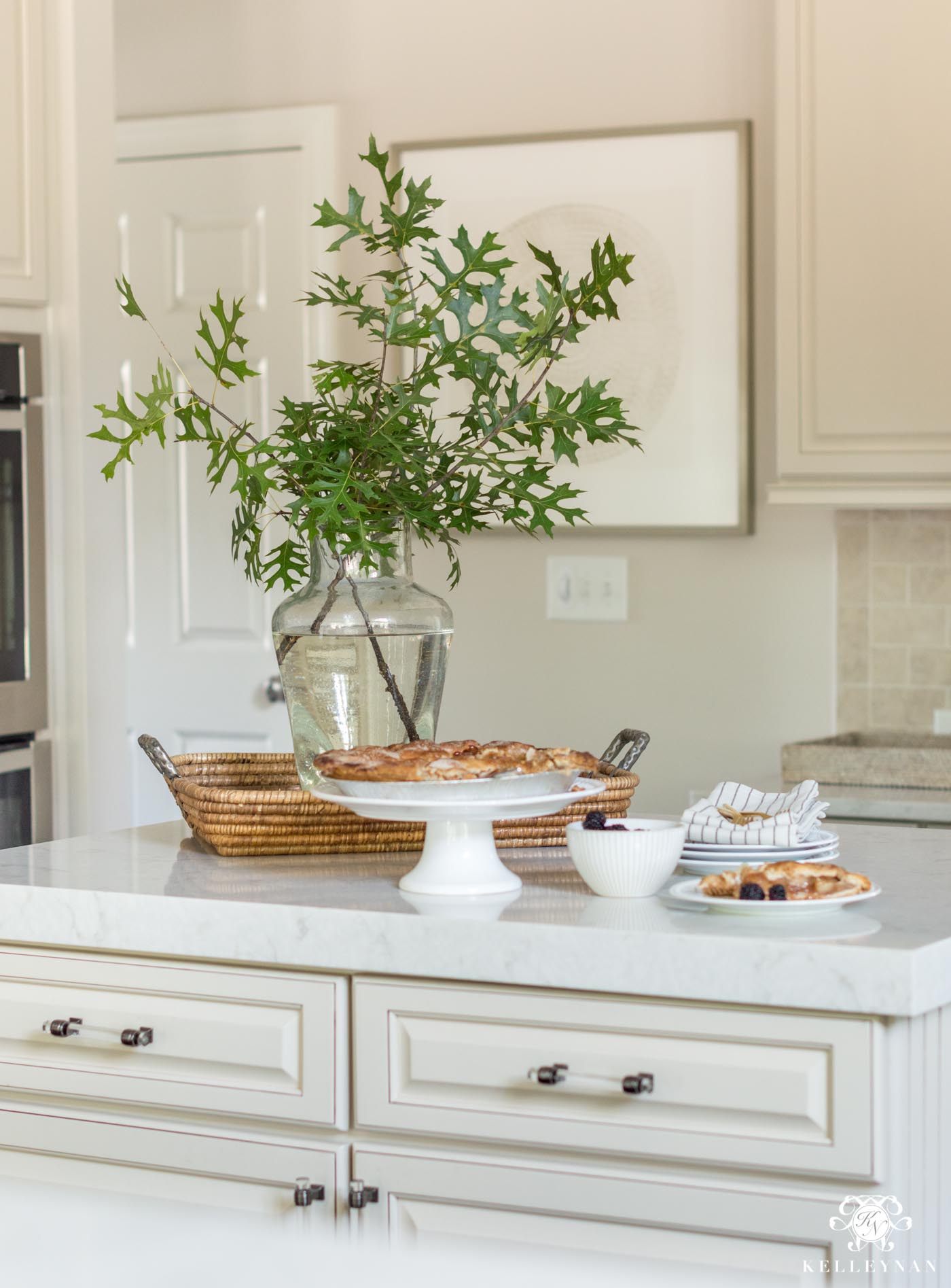 https://kelleynan.com/wp-content/uploads/2018/09/Kitchen-Island-Styling-with-green-leaves.jpg