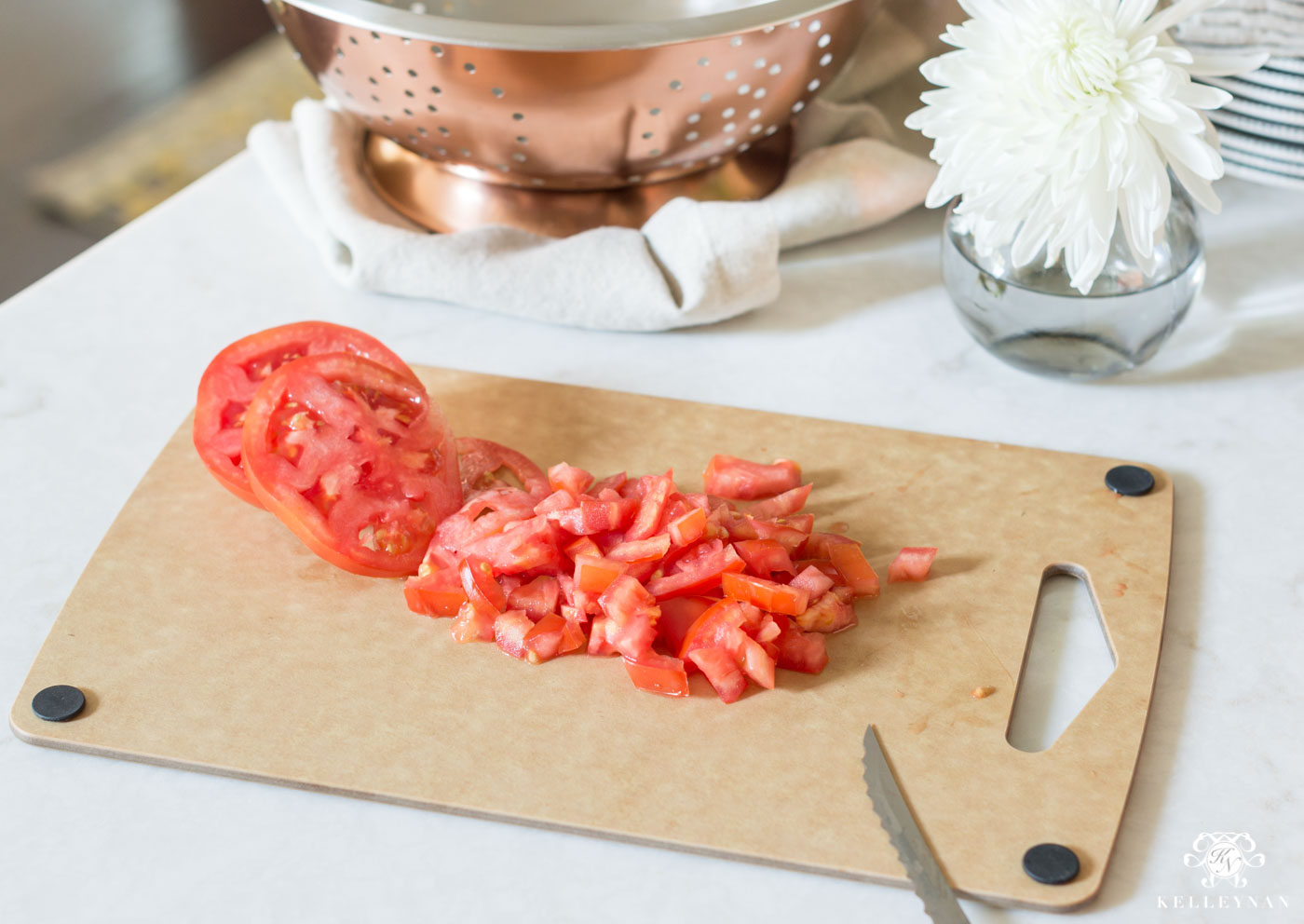 Chopping tomatoes on cutting board