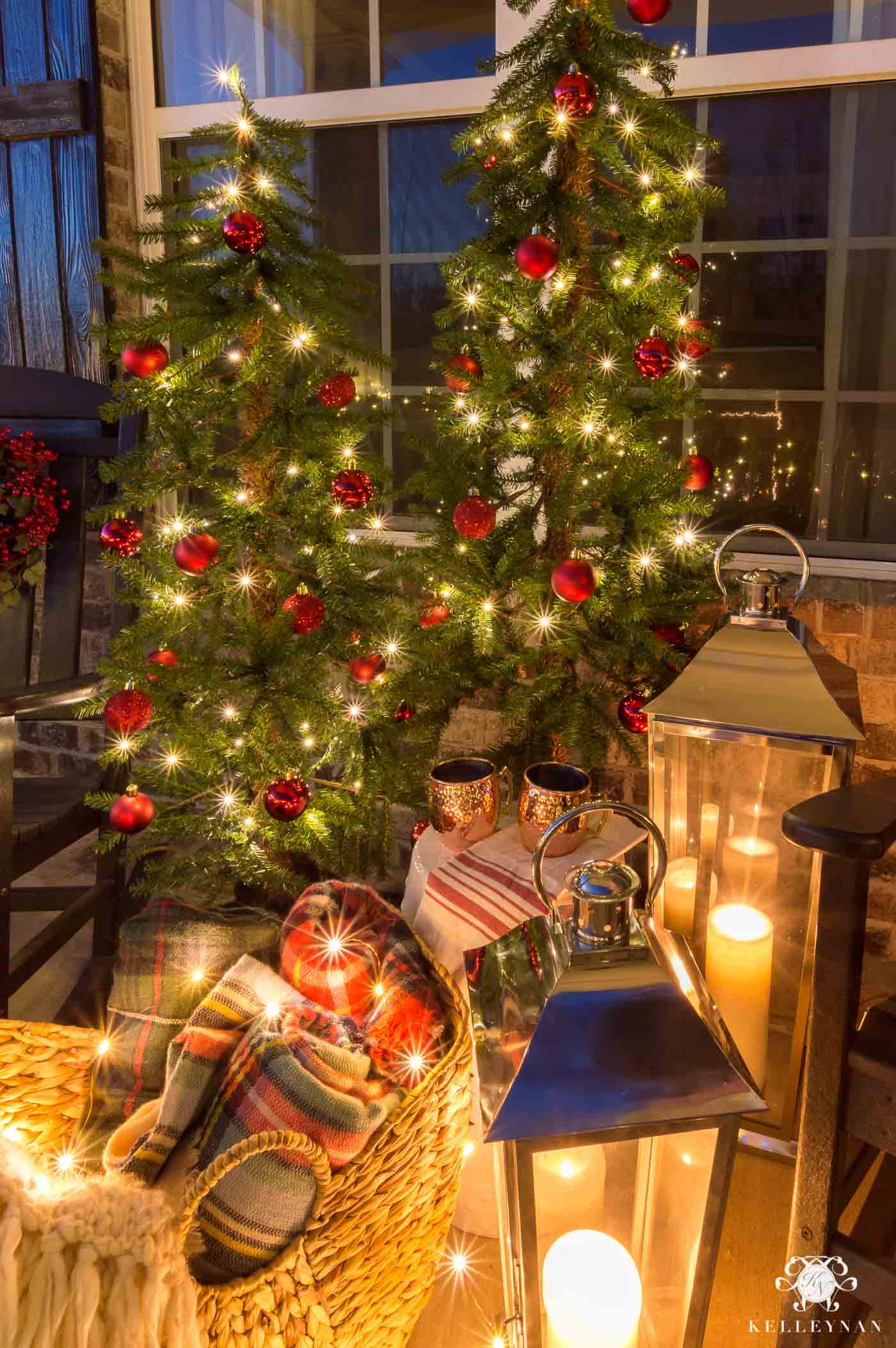 Traditional Christmas decorations on the front porch with cozy lanterns and throw blankets