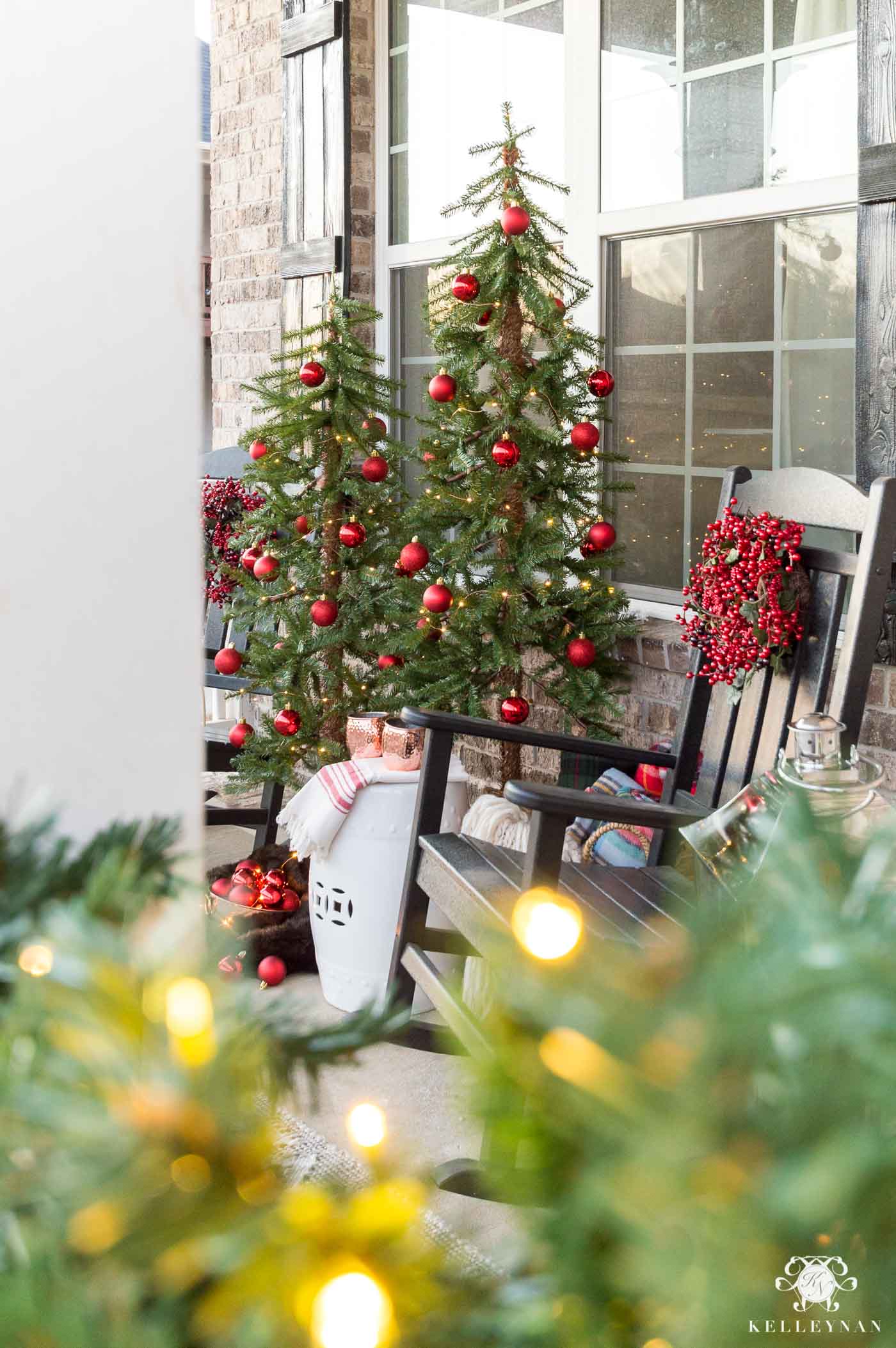 Rocking Chair Front Porch Decorated in Christmas Trees and Red Decorations