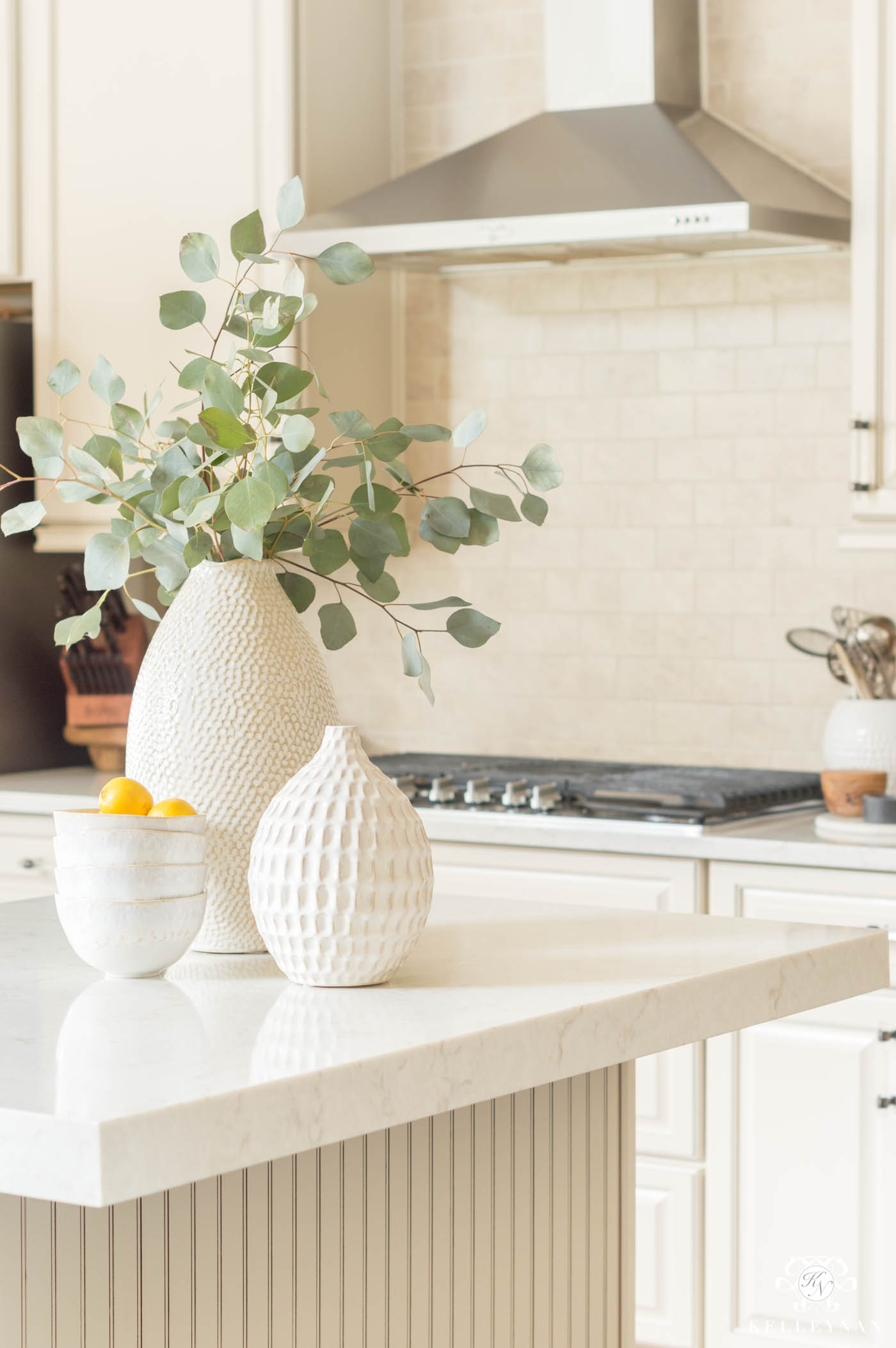 Kitchen island decor and clusters of vases