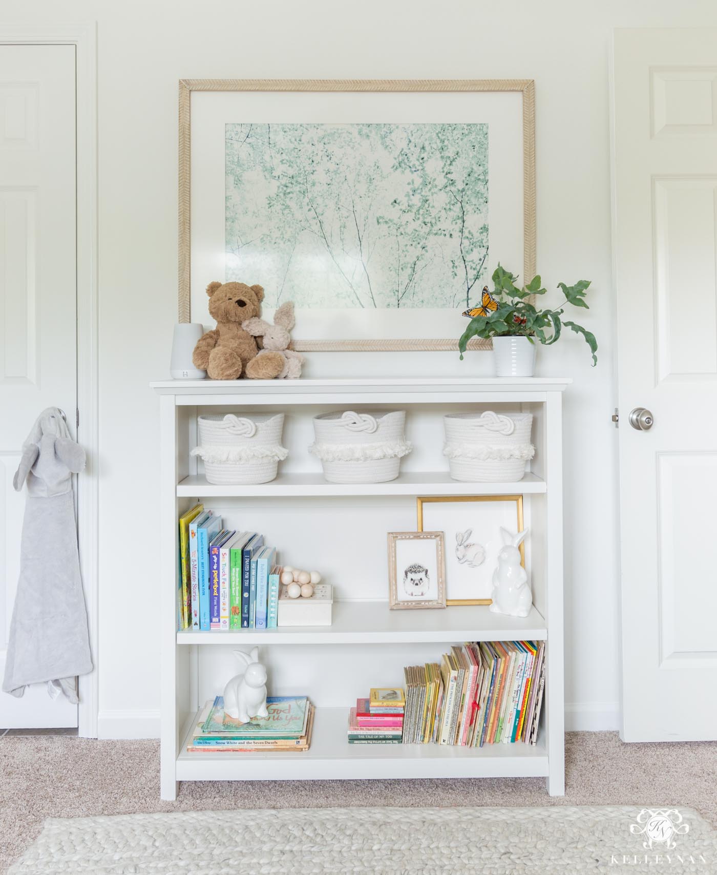 Gender neutral nursery styled bookcase with books and toys