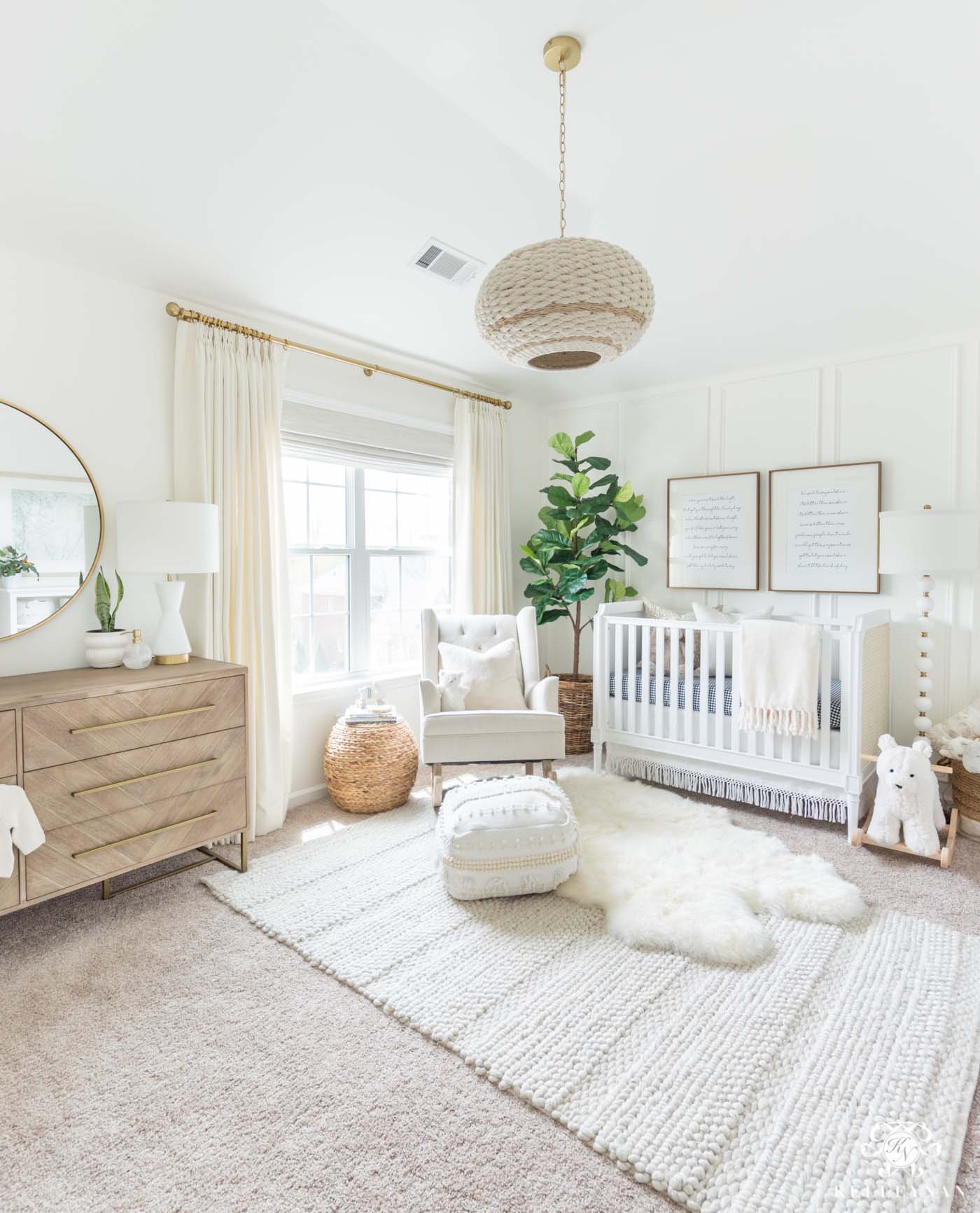 Beautiful gender neutral nursery design with white walls and woodland decor - soft, modern, and a little bohemian