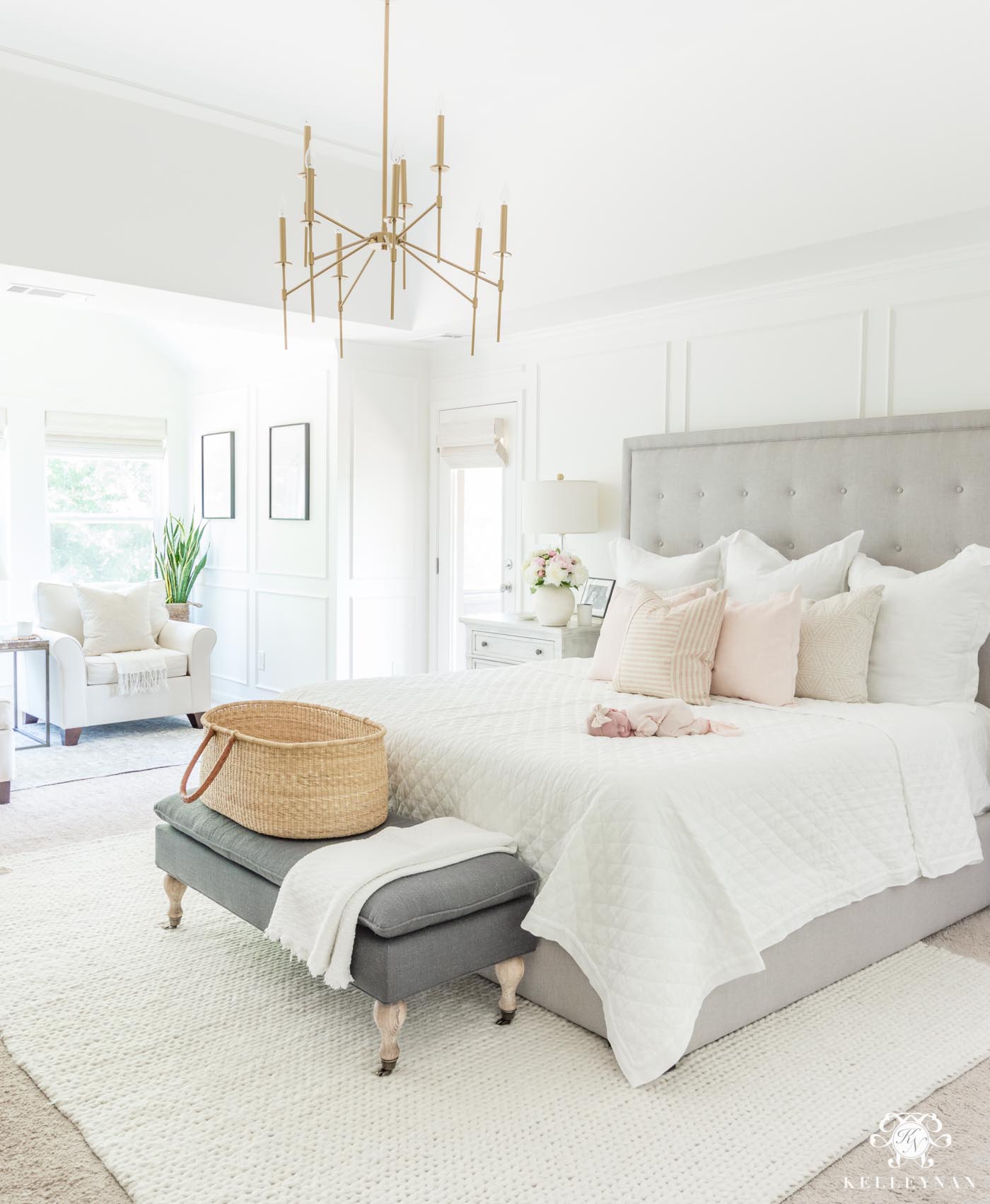 White and pink bedroom decor with gray tufted headboard