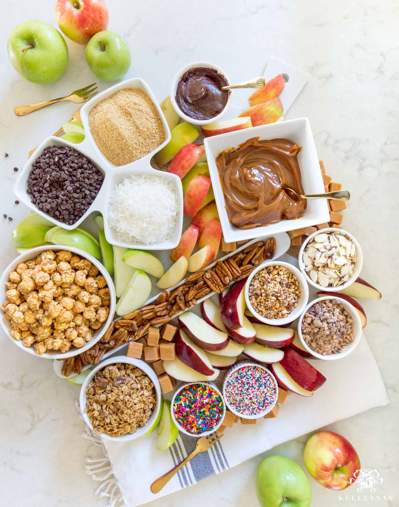 The perfect fall appetizer idea: a caramel apple board with all the toppings!