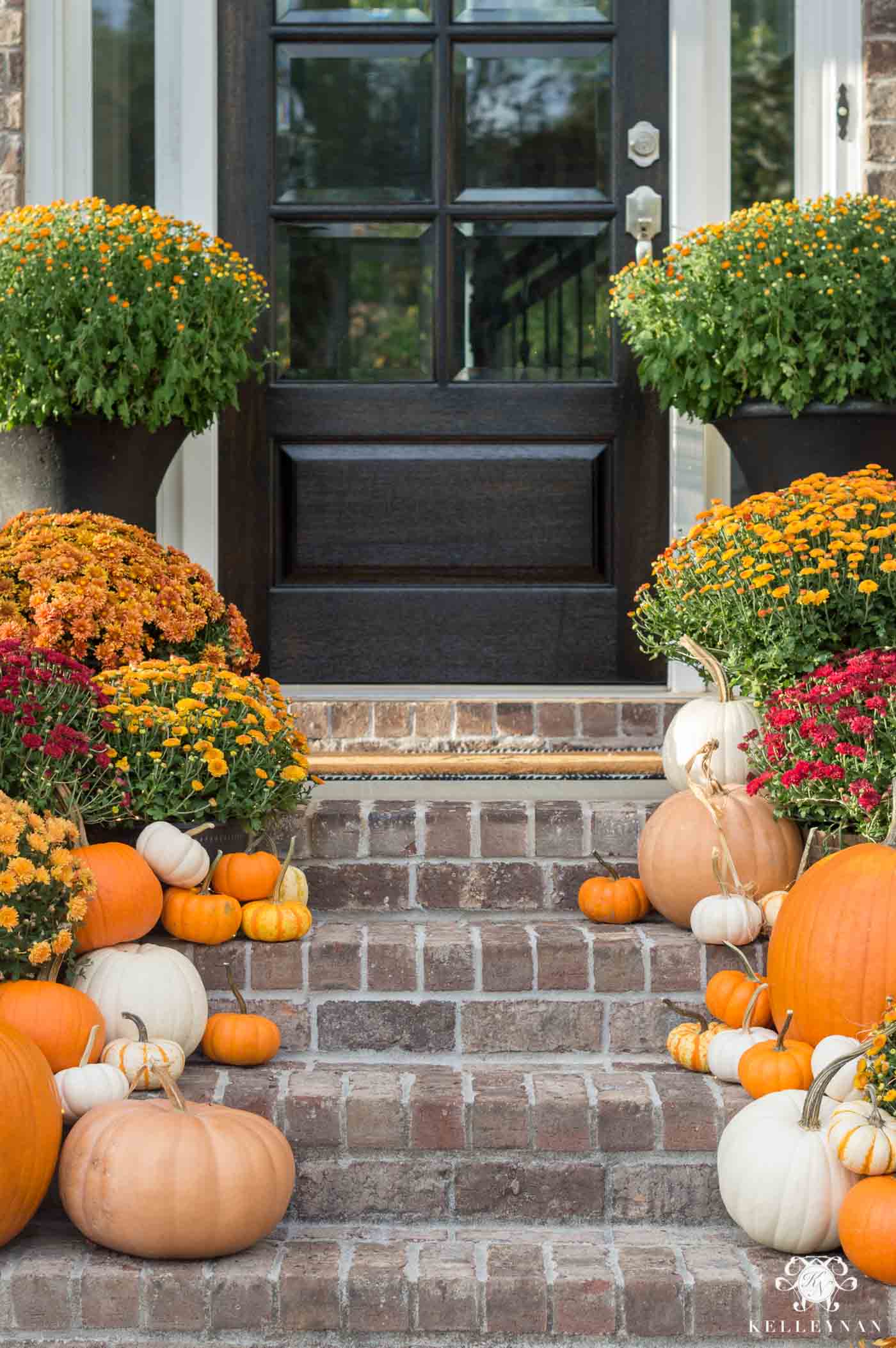 Fall porch decor with mums and pumpkins