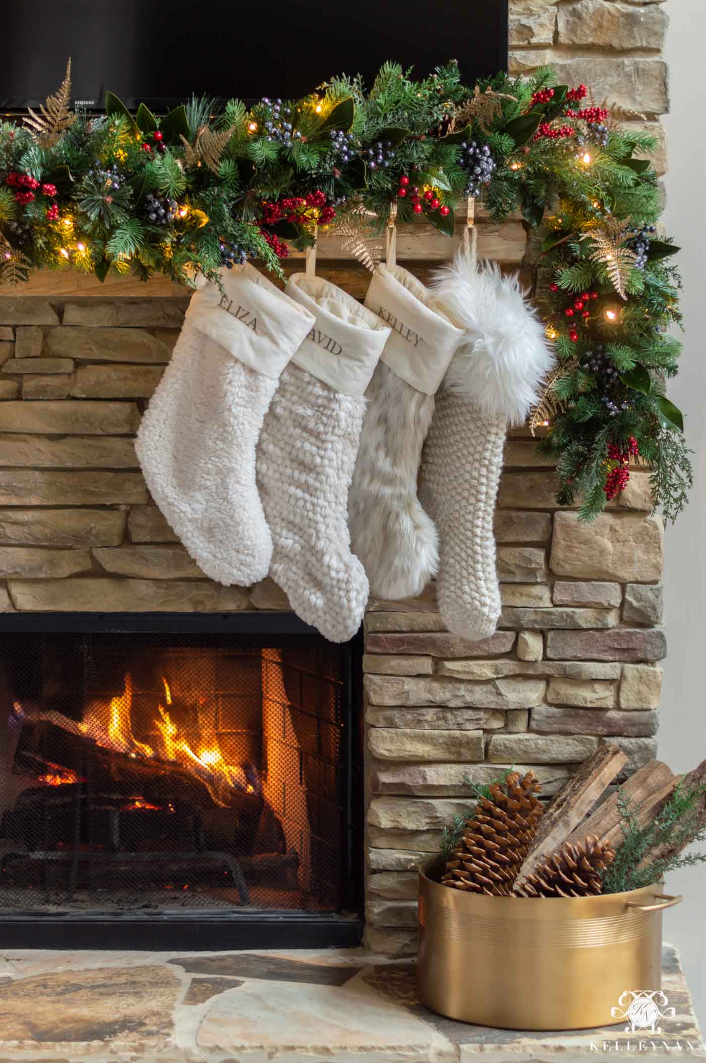 Christmas Fireplace Decor with Greenery and Fur Stockings