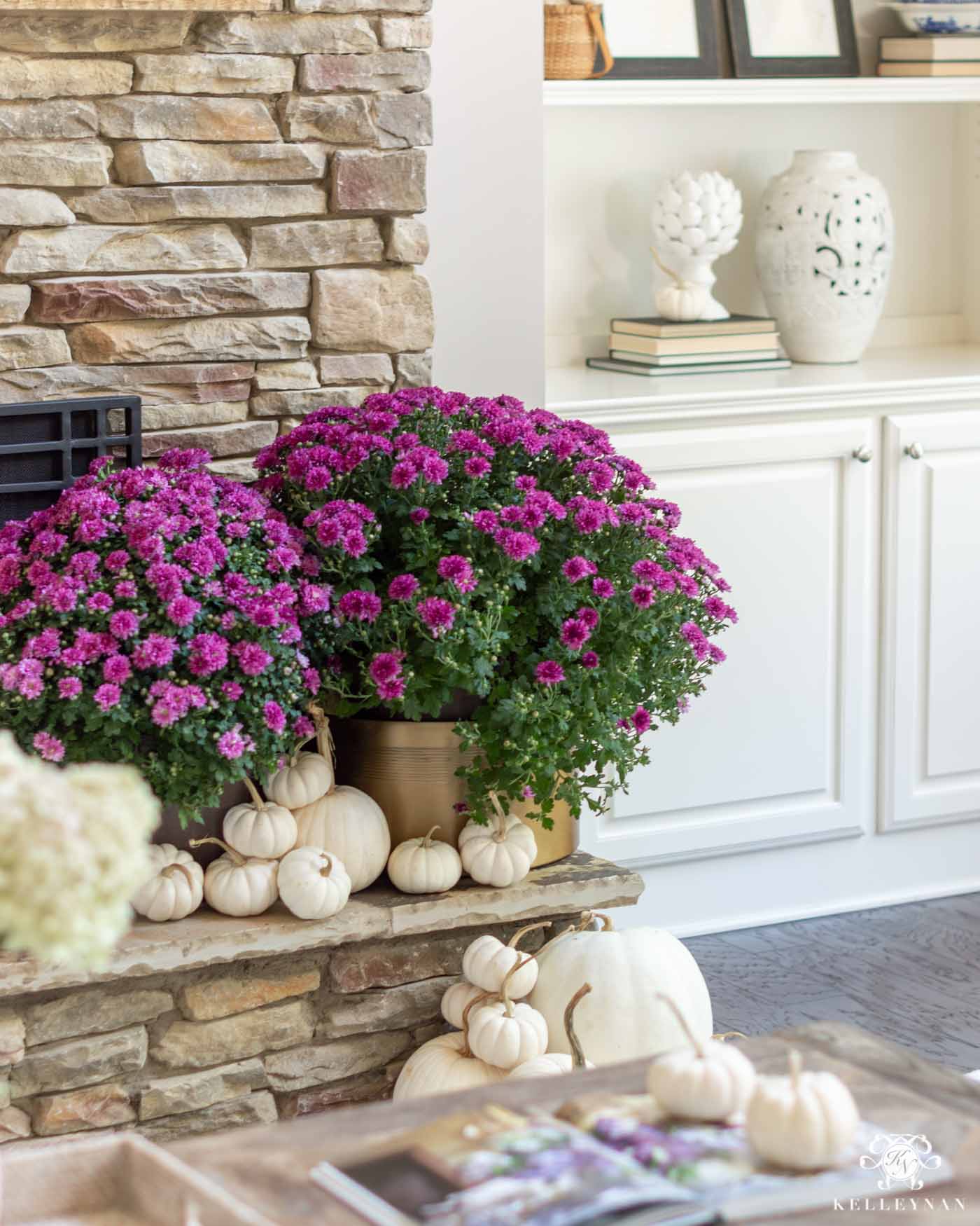 Fall Fireplace Decorating Ideas with White Pumpkins and Purple Mums