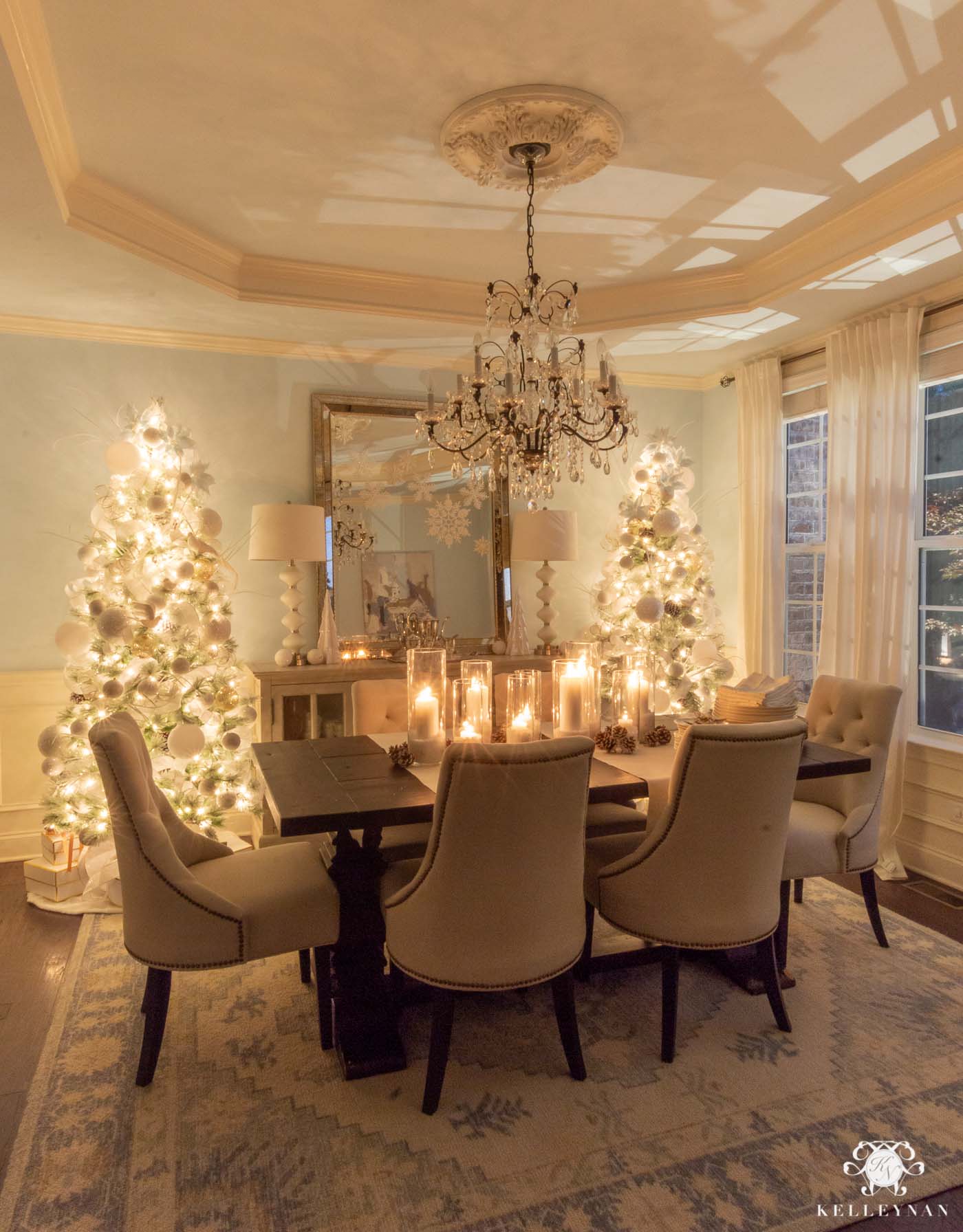 Cozy Christmas Decor -- Matching Flocked Christmas trees and Candlelight in the Dining Room