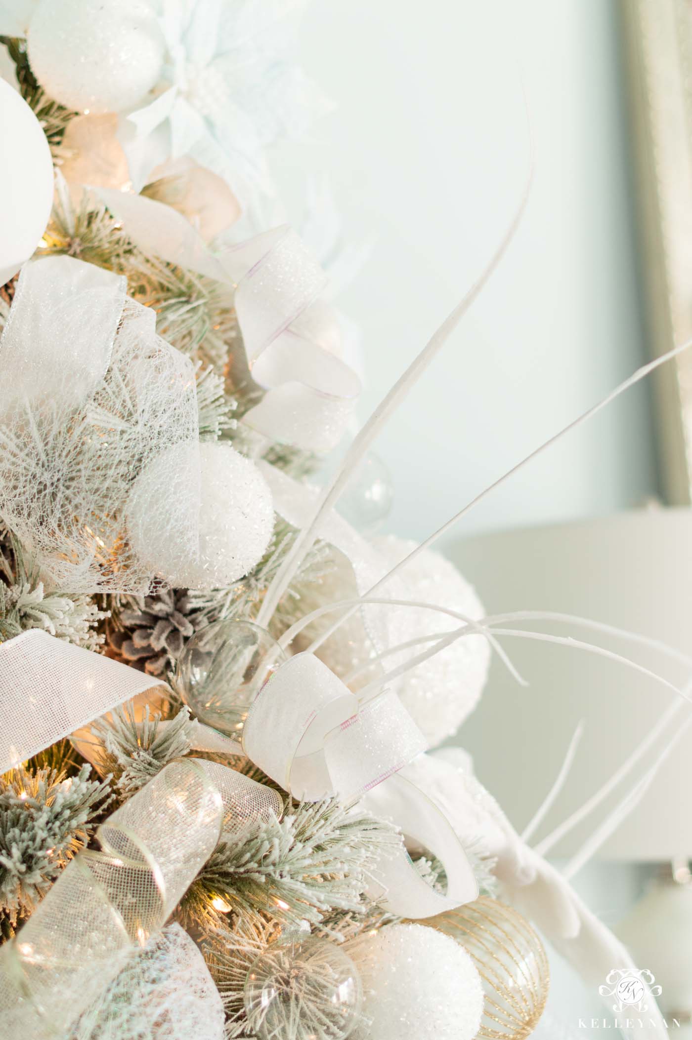 White Ornaments on Flocked, White Christmas Trees with Pale Blue Accents