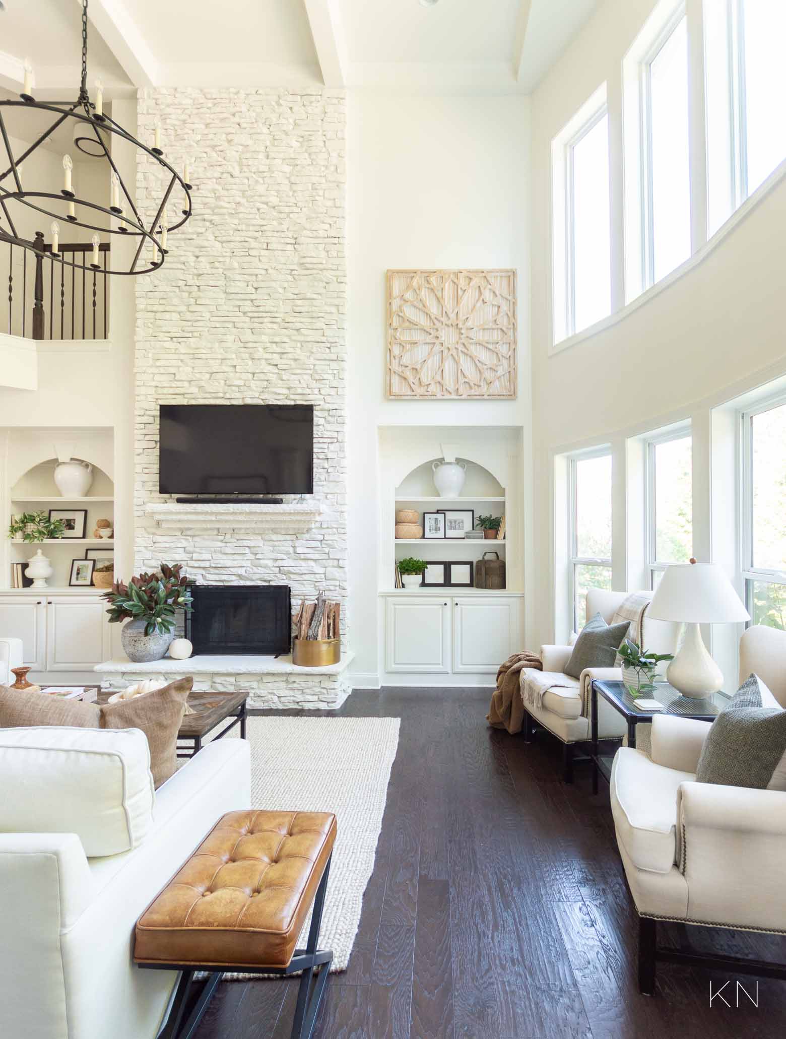 White Living Room Design with Statement Two Story Painted Stone Fireplace