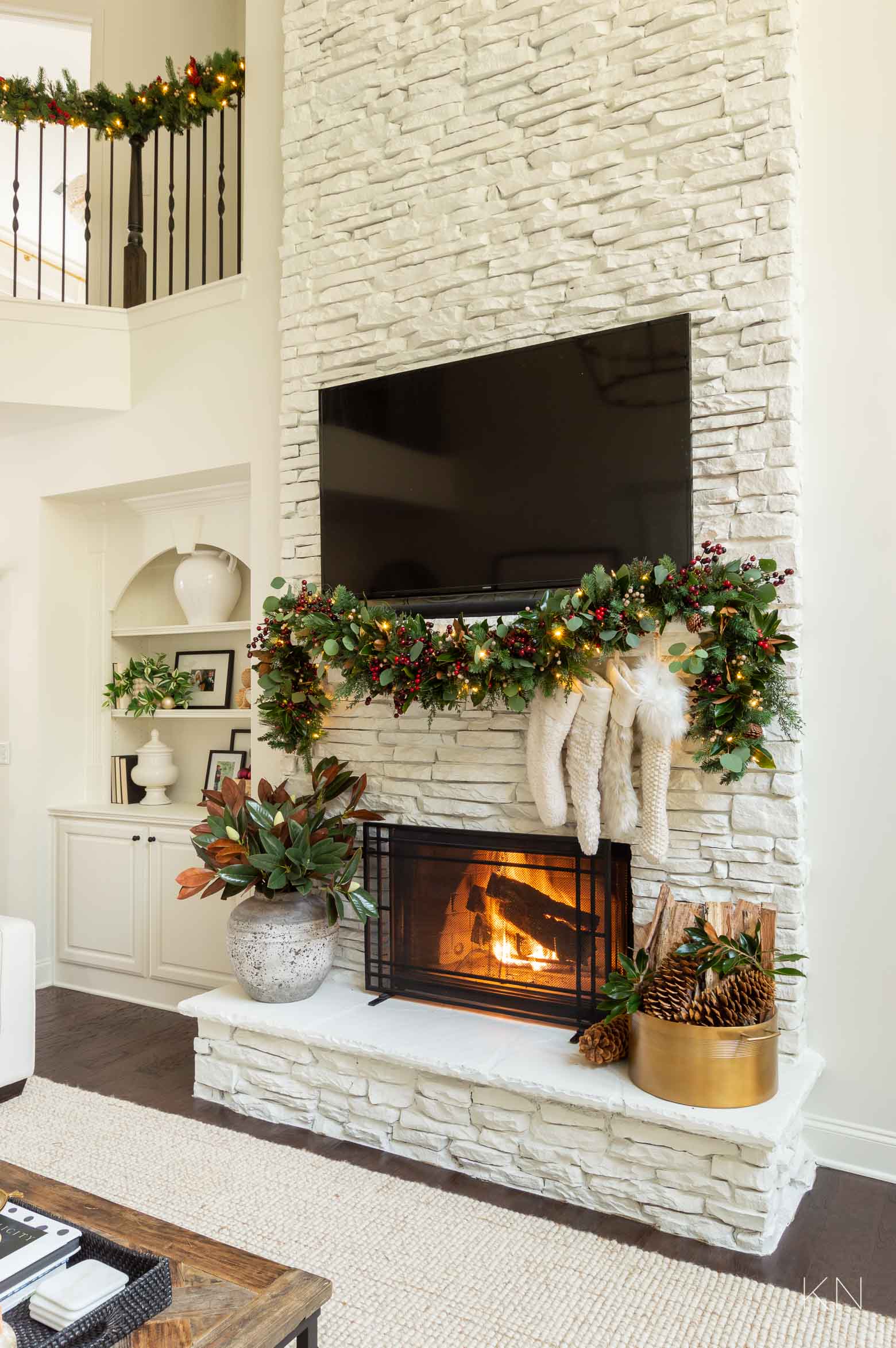 White Stone Fireplace Christmas Decor -- Green Garland with Red Berries and White Stockings