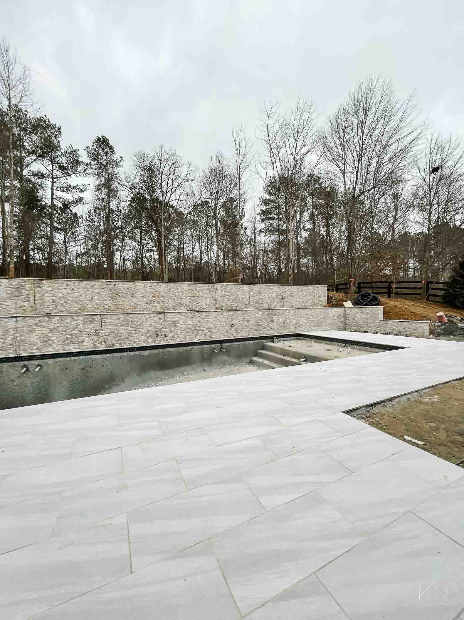 Concrete Pool Building Progress with Retaining Walls