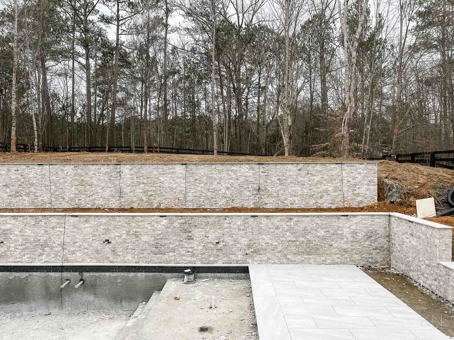 Concrete Pool Building Progress with Retaining Walls