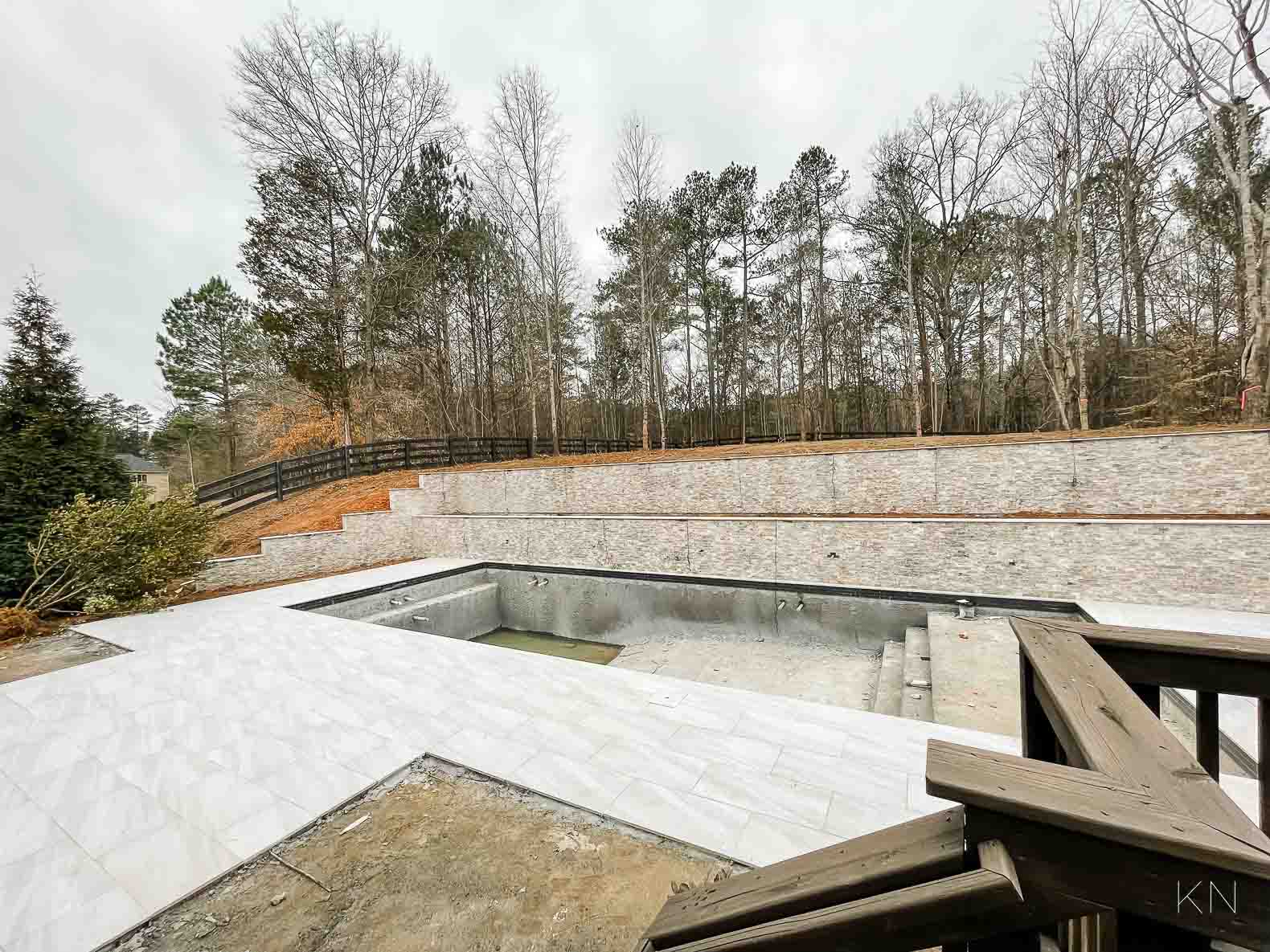 Concrete Pool Building Progress with Retaining Walls