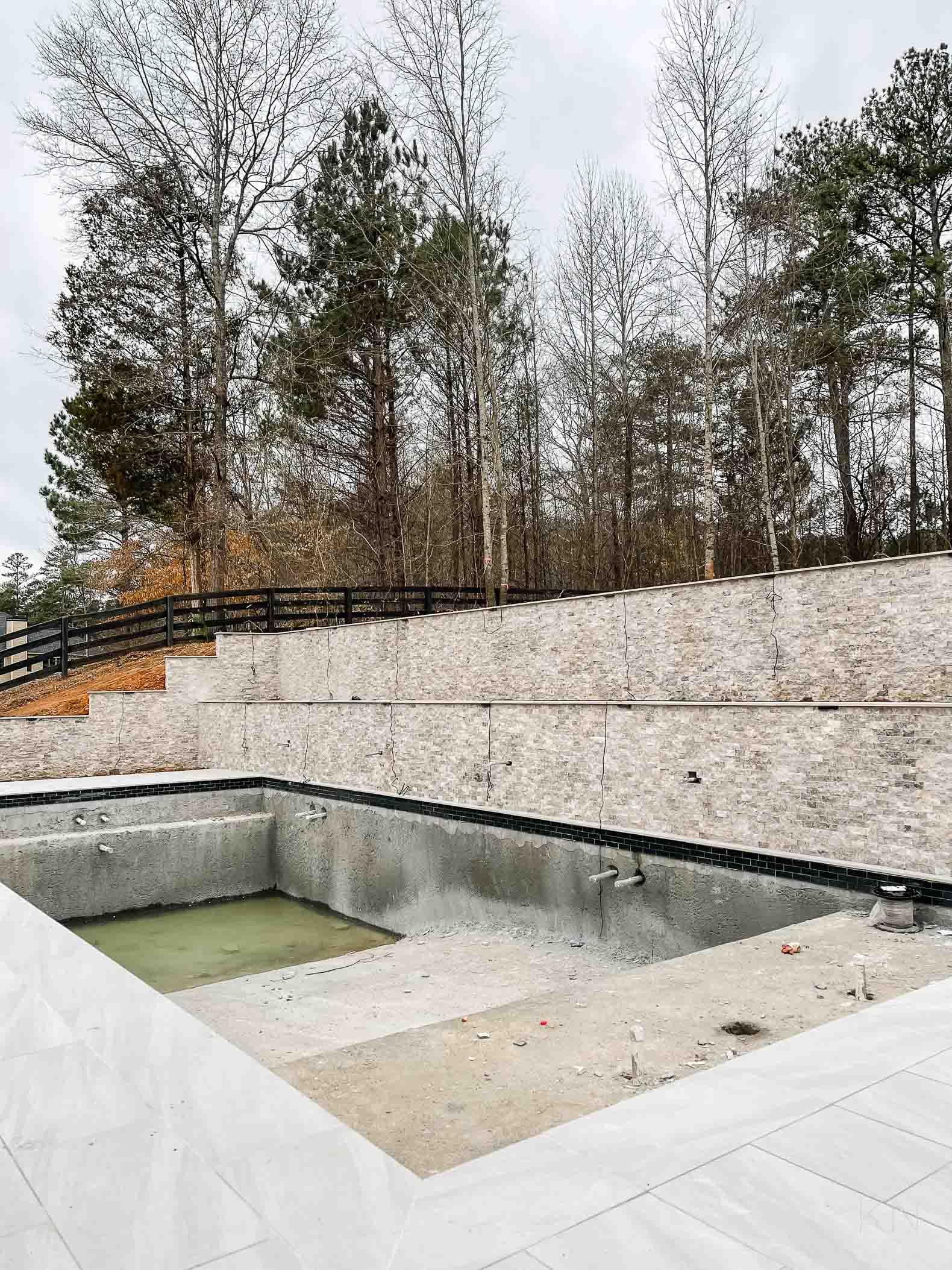 Concrete Pool Building Progress with Retaining Walls