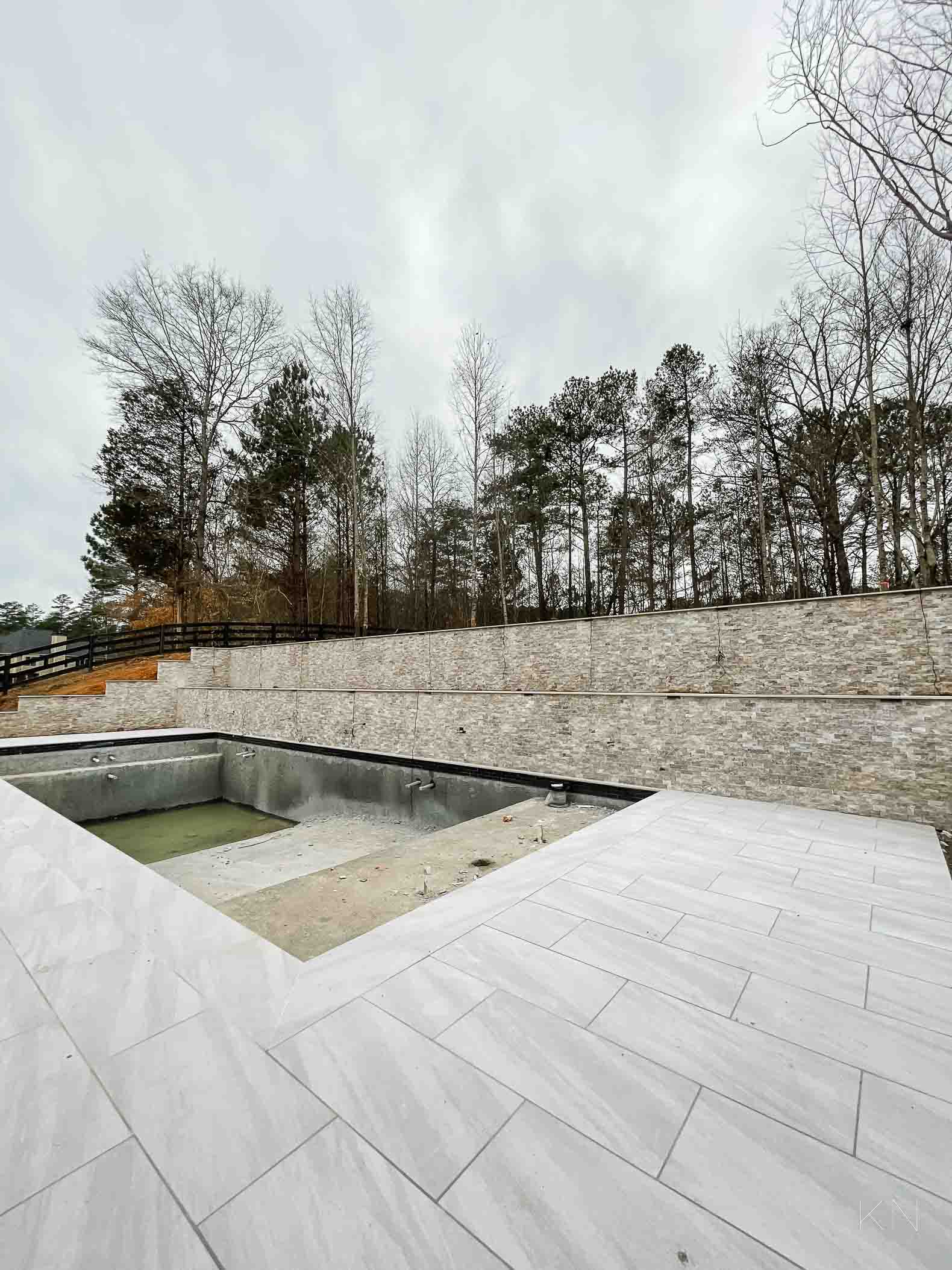 Concrete Pool Building Progress with Retaining Walls