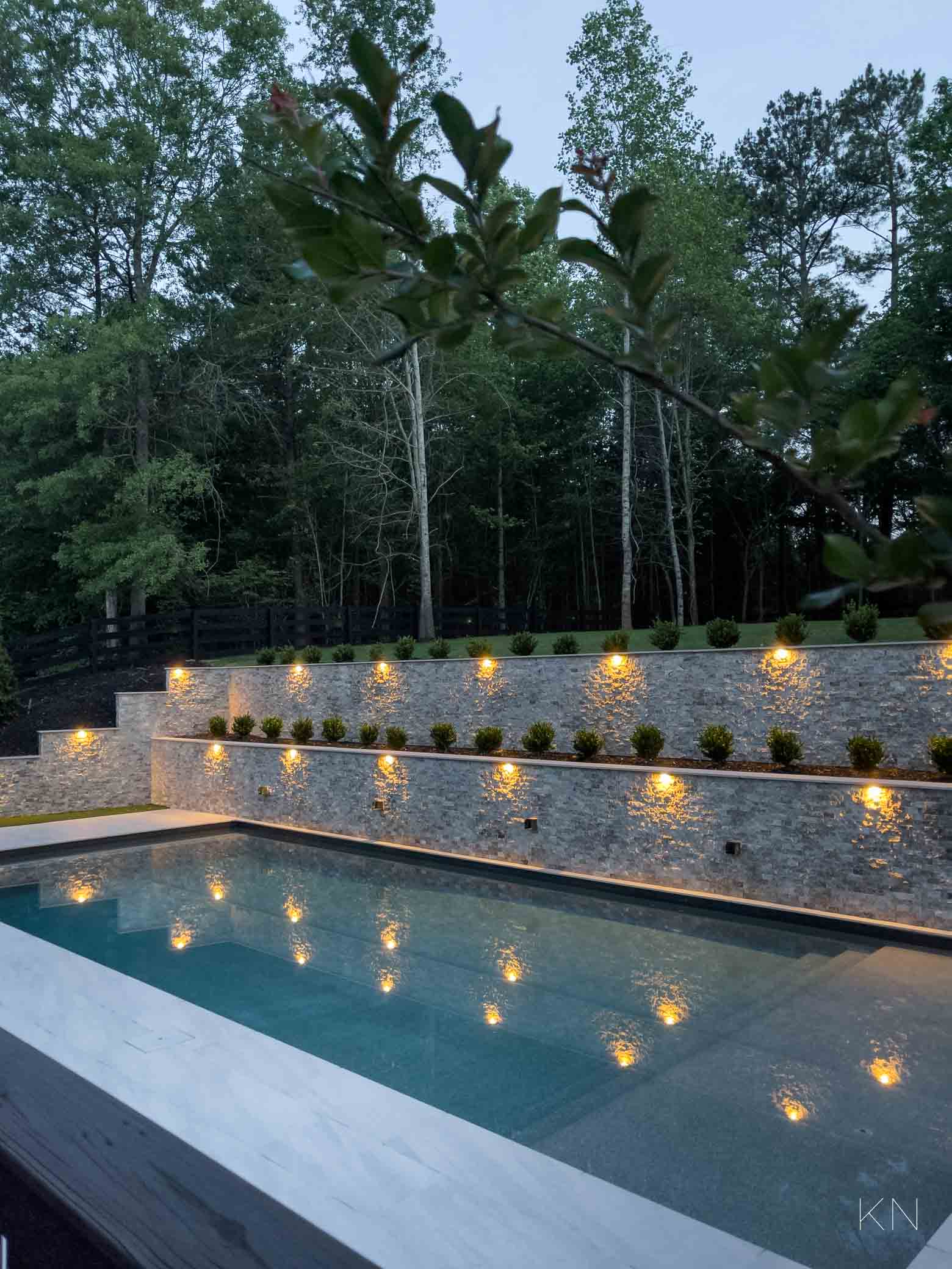 Double Retaining Wall Design with Landscape Lighting and Boxwoods
