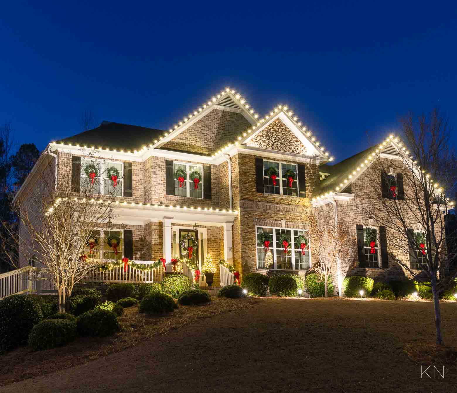 Christmas Wreaths On Windows with Red Bows and Lights